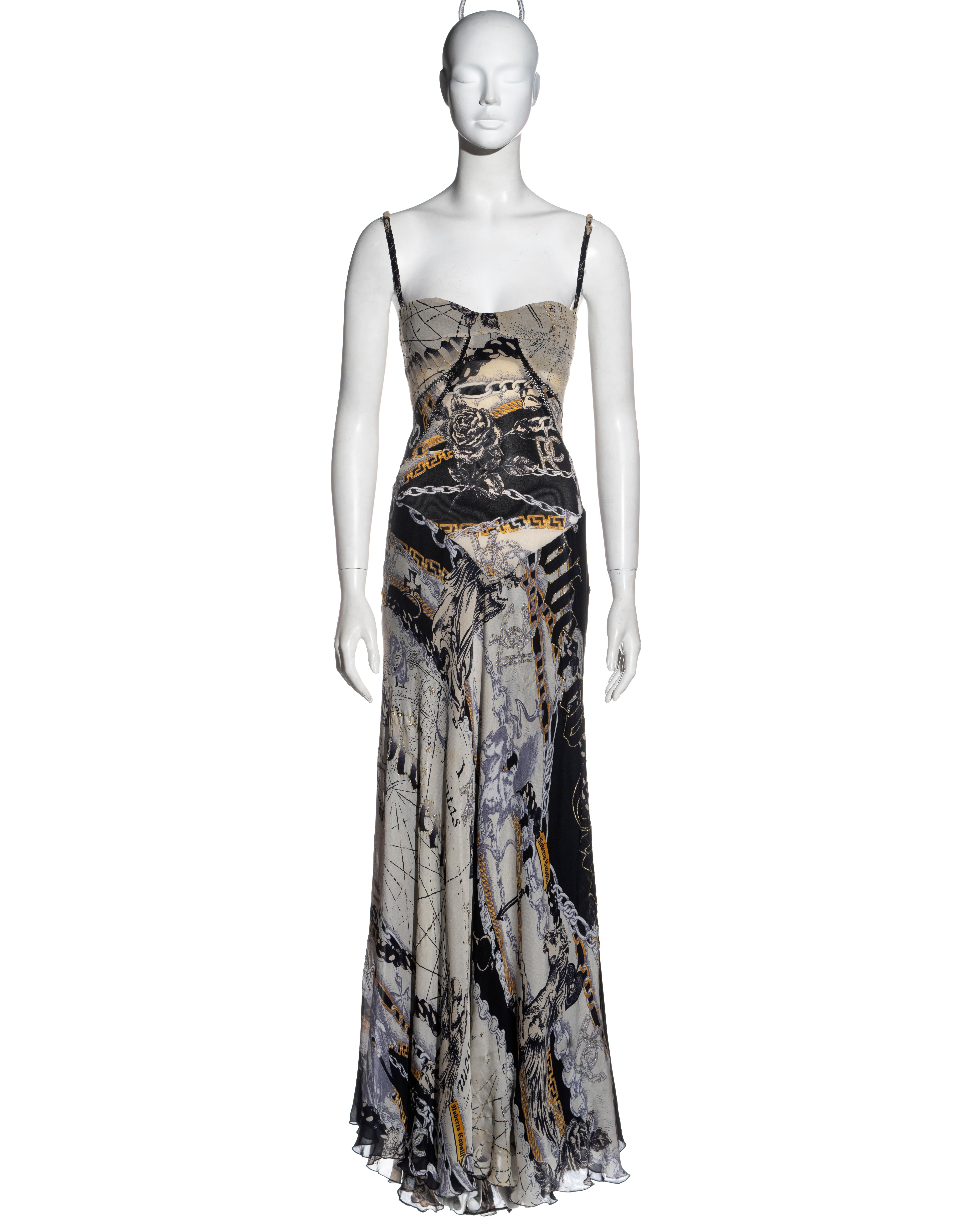▪ Roberto Cavalli zodiac printed silk evening dress
▪ Zodiac print with chains, roses and gothic text 
▪ Gold glitter detail on parts of the fabric 
▪ Corset lace-up fastening 
▪ Built-in bra
▪ Floor-length skirt with train 
▪ Open seams with