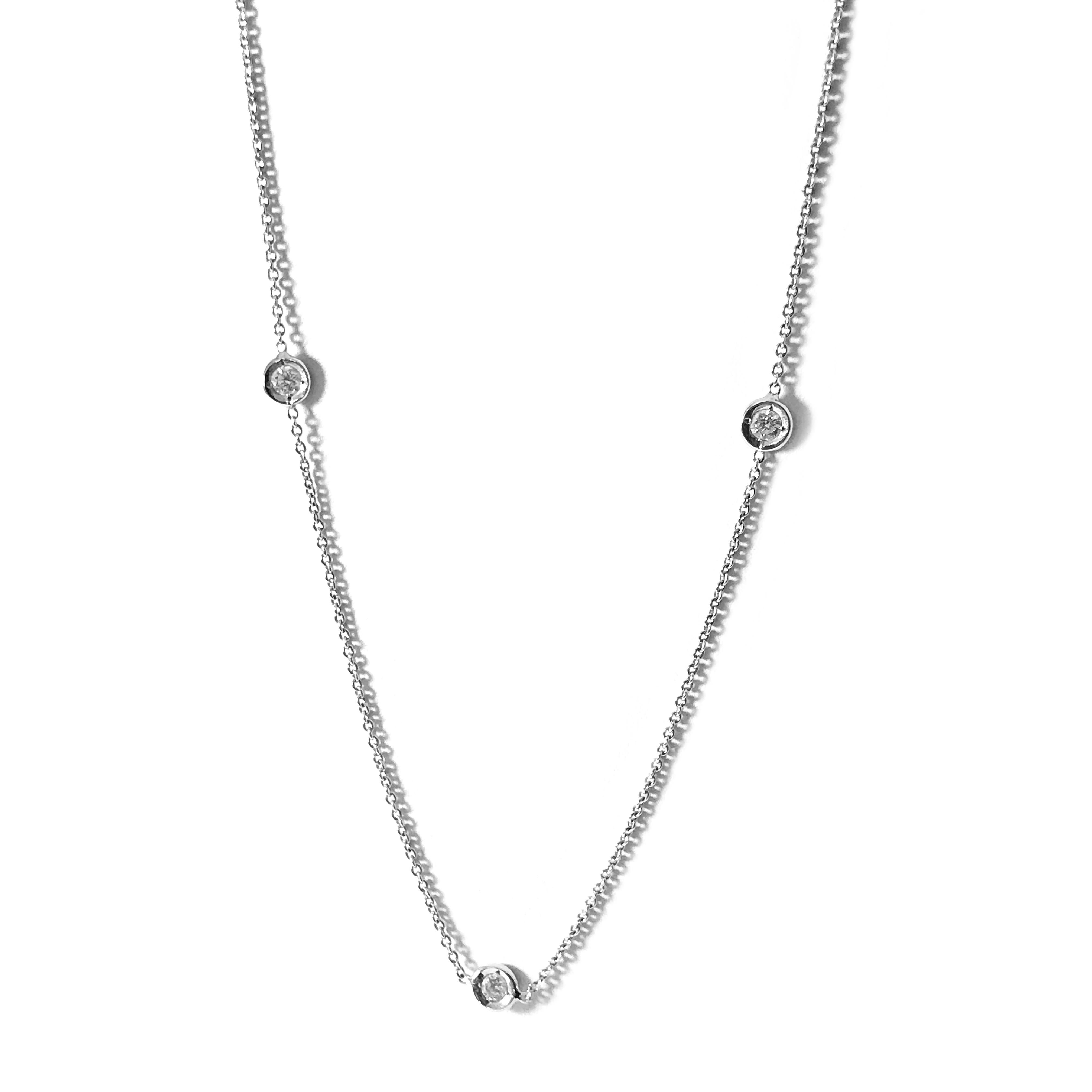 Classic Roberto Coin 18 Karat Diamonds By The Inch Necklace. Three exquisite diamonds are showcased in circle stations. Diamonds are VS  (G.I.A.) in clarity and G-H (G.I.A.)  in color for a total weight of 0.15ctw. A single Ruby cabochon is featured