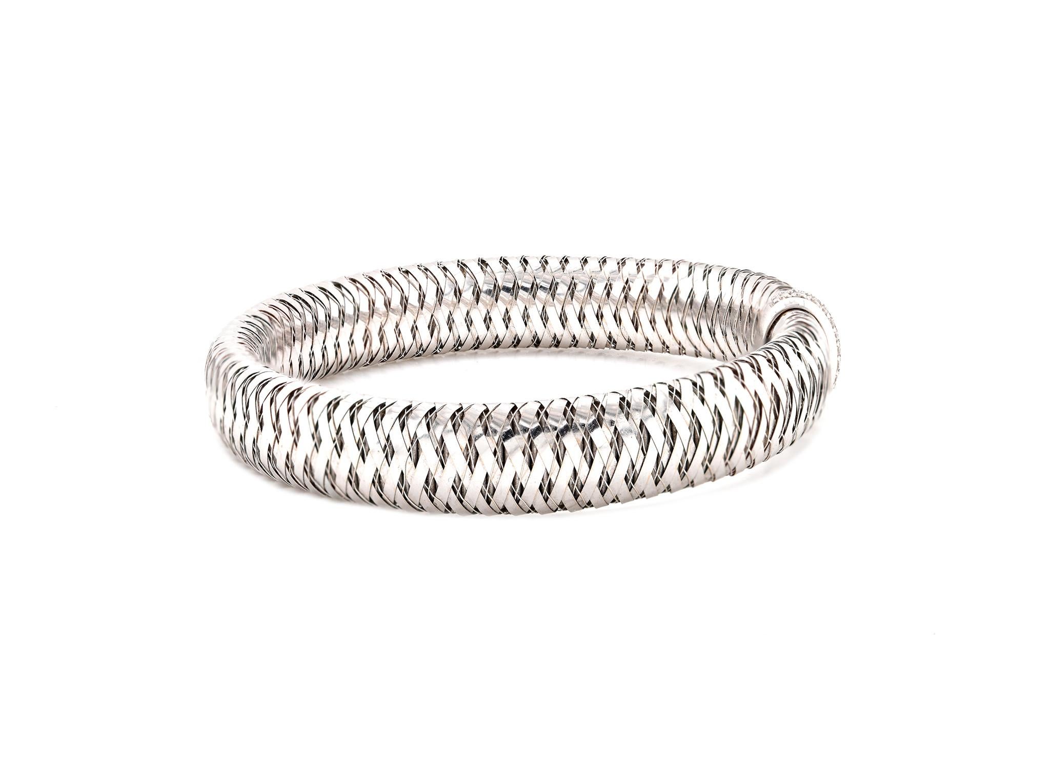 Designer: Roberto Coin 
Material: 18k white gold
Diamonds: 26 round brilliant cuts = .25cttw
Color: G
Clarity: VS1
Dimensions: bracelet will fit up to a 7-inch wrist
Weight: 27.76 grams
