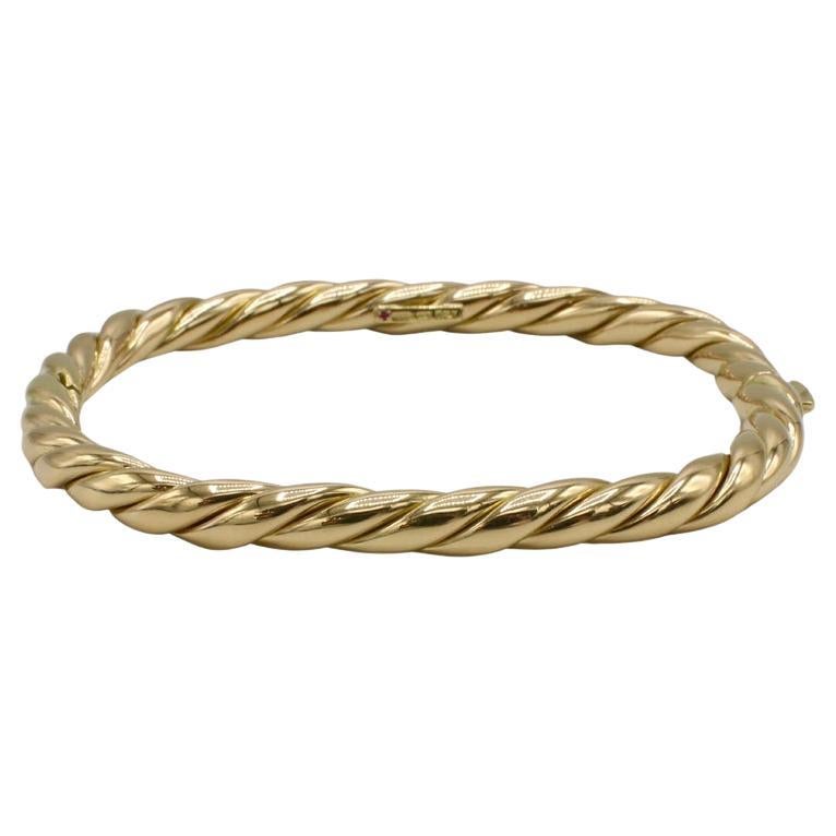 Roberto Coin 18 Karat Yellow Gold Twist Bangle Bracelet 
Metal: 18k yellow gold
Weight: 28.59 grams
Width: 5.5mm
Circumference: 7.5 inches
Signed: ITALY 18k signautre Roberto Coin ruby and hallmarks 
