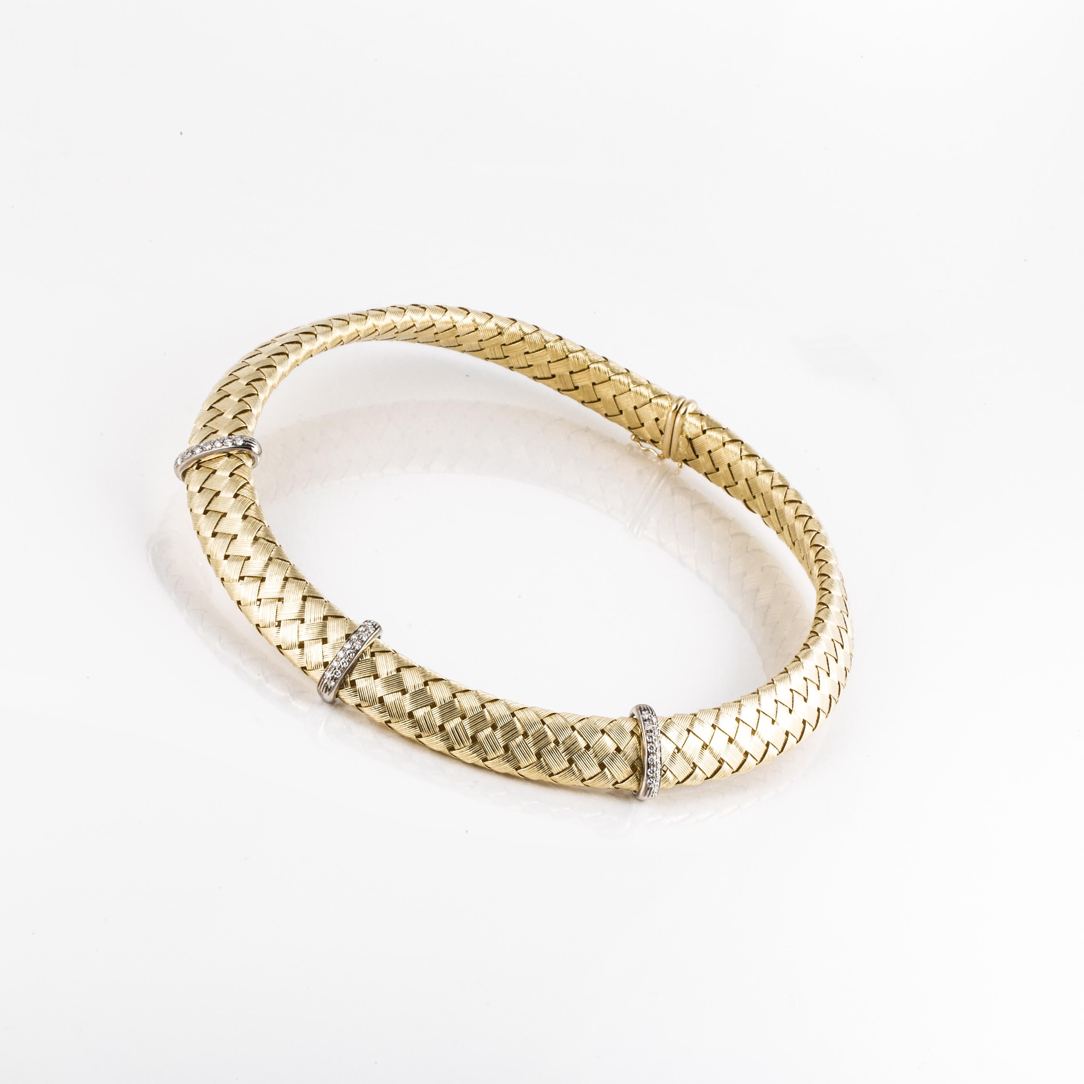 Classic style woven choker necklace by Roberto Coin.  It is 18K yellow gold with three plaques of diamonds set in white gold.  There are forty-two (42) round diamonds with total carat weight of 0.80; they are G-H in color and VS in clarity. 