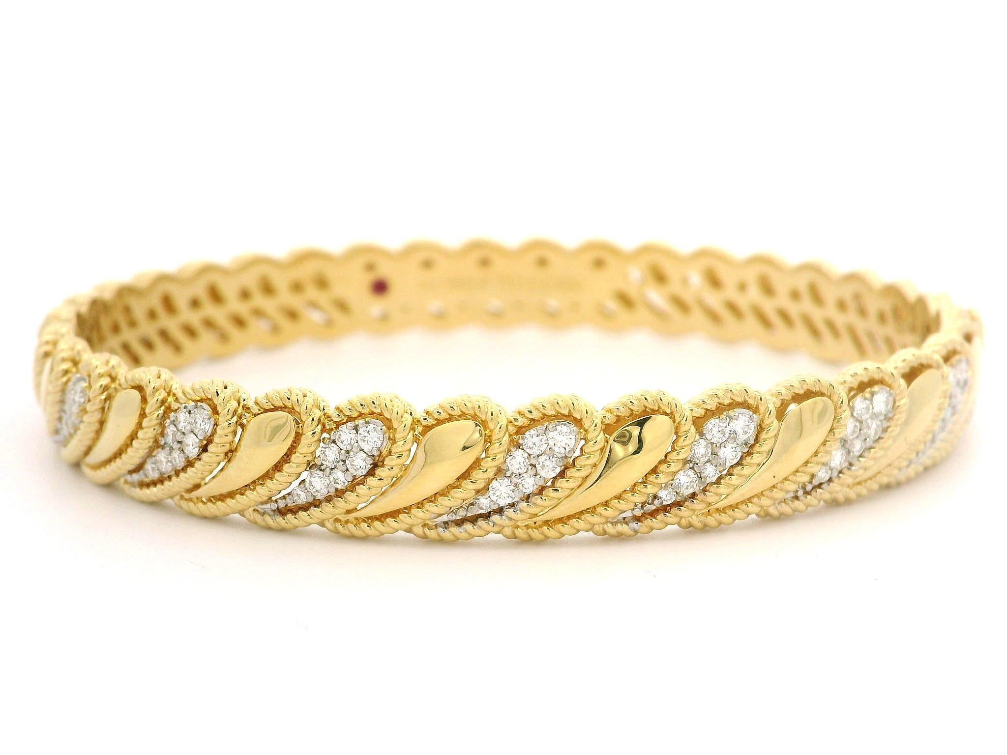 –Stone(s)–
(56) Natural Genuine Diamonds - Round Brilliant Cut - Pave Set - F/G Color - VS1/VS2 Clarity - 0.47ctw (approx.)
(1) Red Stone - Round Cut - Bezel Set
Total Carat Weight: 0.47ctw (approx.)

Material: 18k Yellow & White Gold 
Weight: 25.89