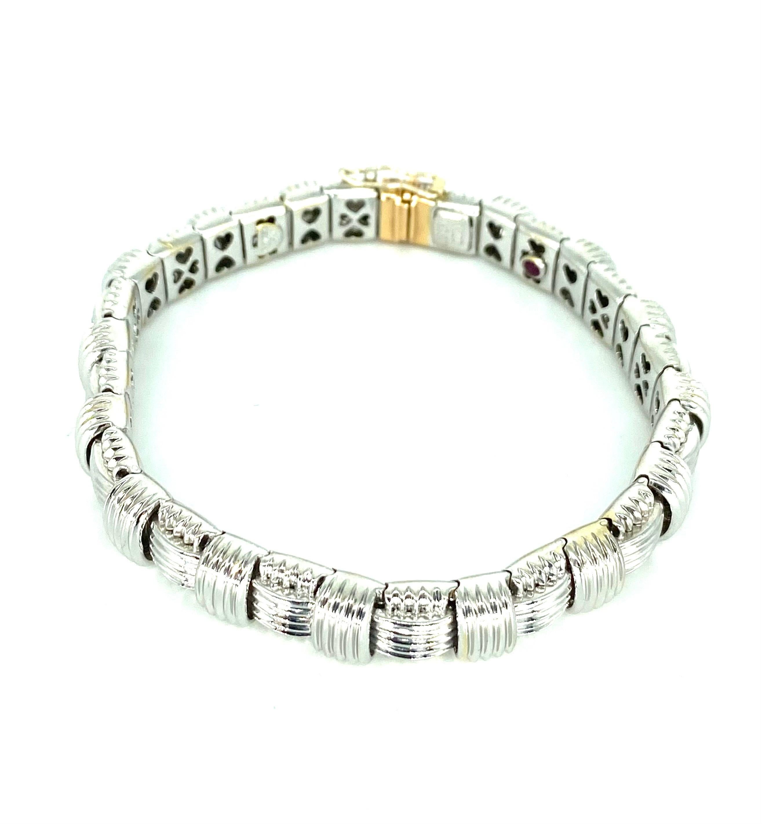 Hallmarks: Roberto Coin 18K Italy

Composition: 18K White Gold with Diamond set in Rose gold

Primary Stone: Diamonds

Bracelet length: 7 Inches

Bracelet width: 8.5mm

Bracelet Weight: 34.9 grams

Bracelet Condition: excellent estate condition,