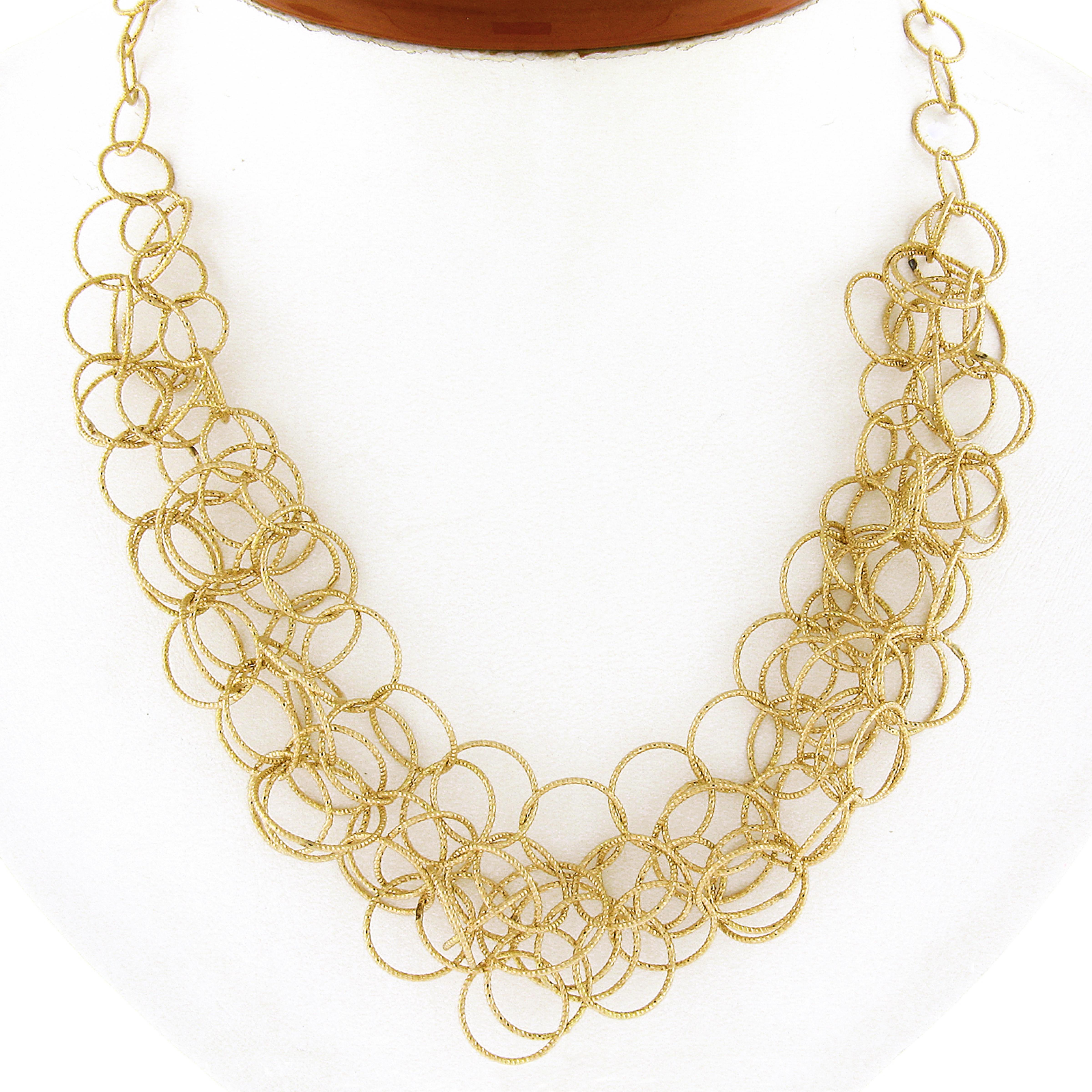 This fancy Roberto Coin chain necklace was crafted in Italy from solid 18k yellow gold and features a beautiful mauresque style constructed from interlocking textured round links throughout. These fancy links have a super shiny and attractive look