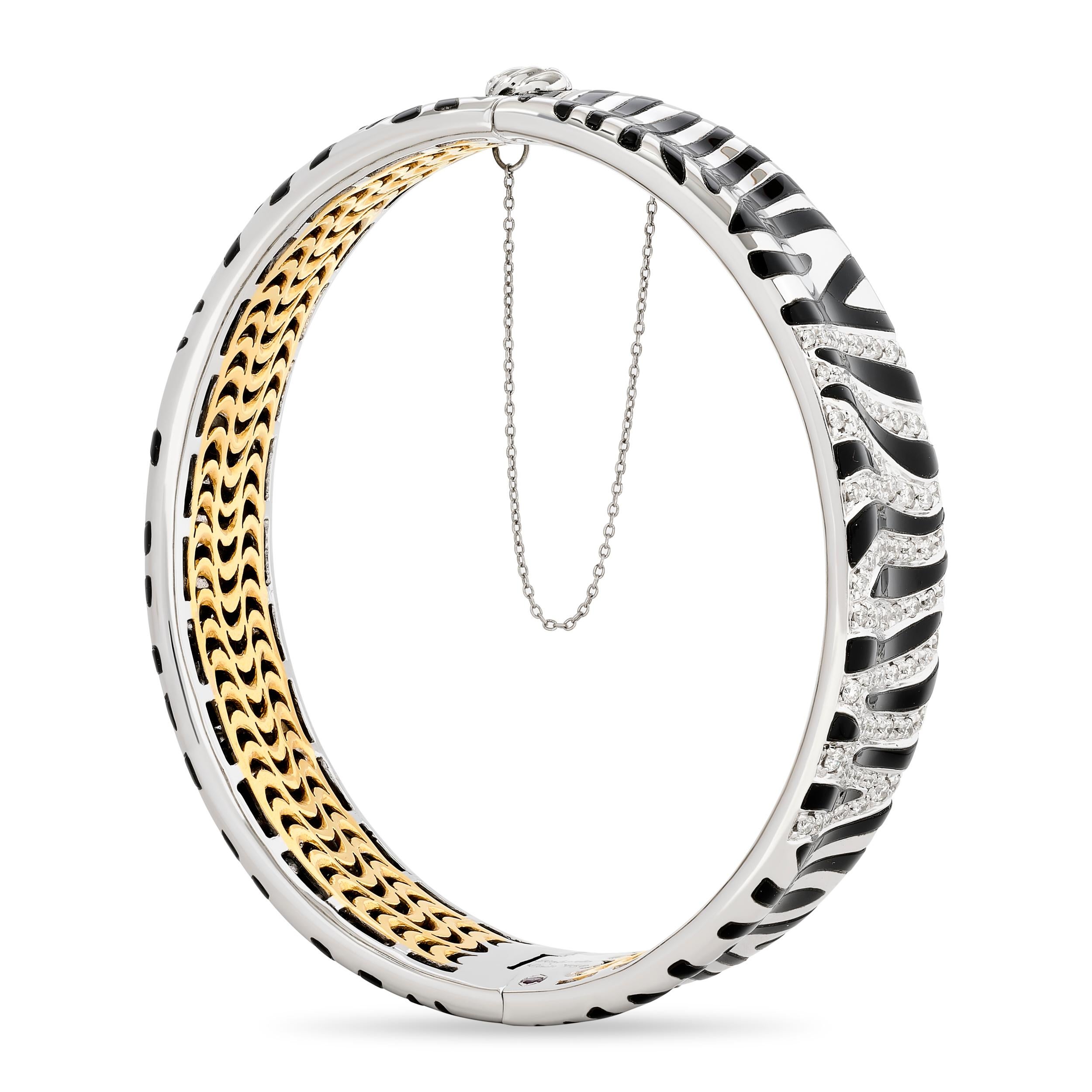 Embrace the wild elegance with this Roberto Coin zebra stripe bangle.

Made in 18 karat two tone - yellow and white gold. 
This bracelet contains approximately 0.85 carats of round brilliant cut diamonds with G, H, I color and SI clarity.  It