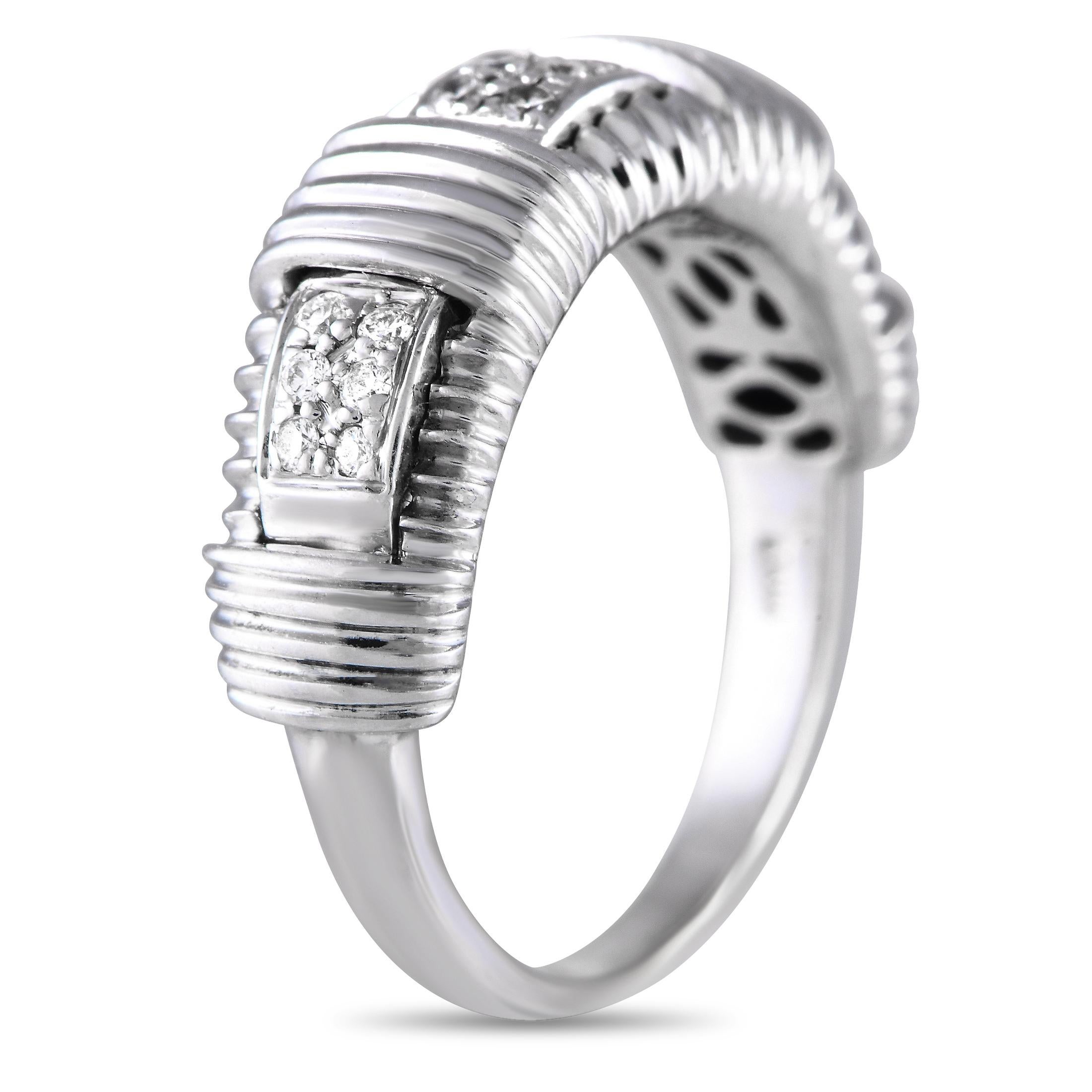 Edgy and elegant at the same time, this Roberto Coin ring in 18K white gold makes a stylish addition to any wardrobe. The tapering band features a wider top with a ridged or grooved profile. Three rectangular bezels filled with petite diamonds bring