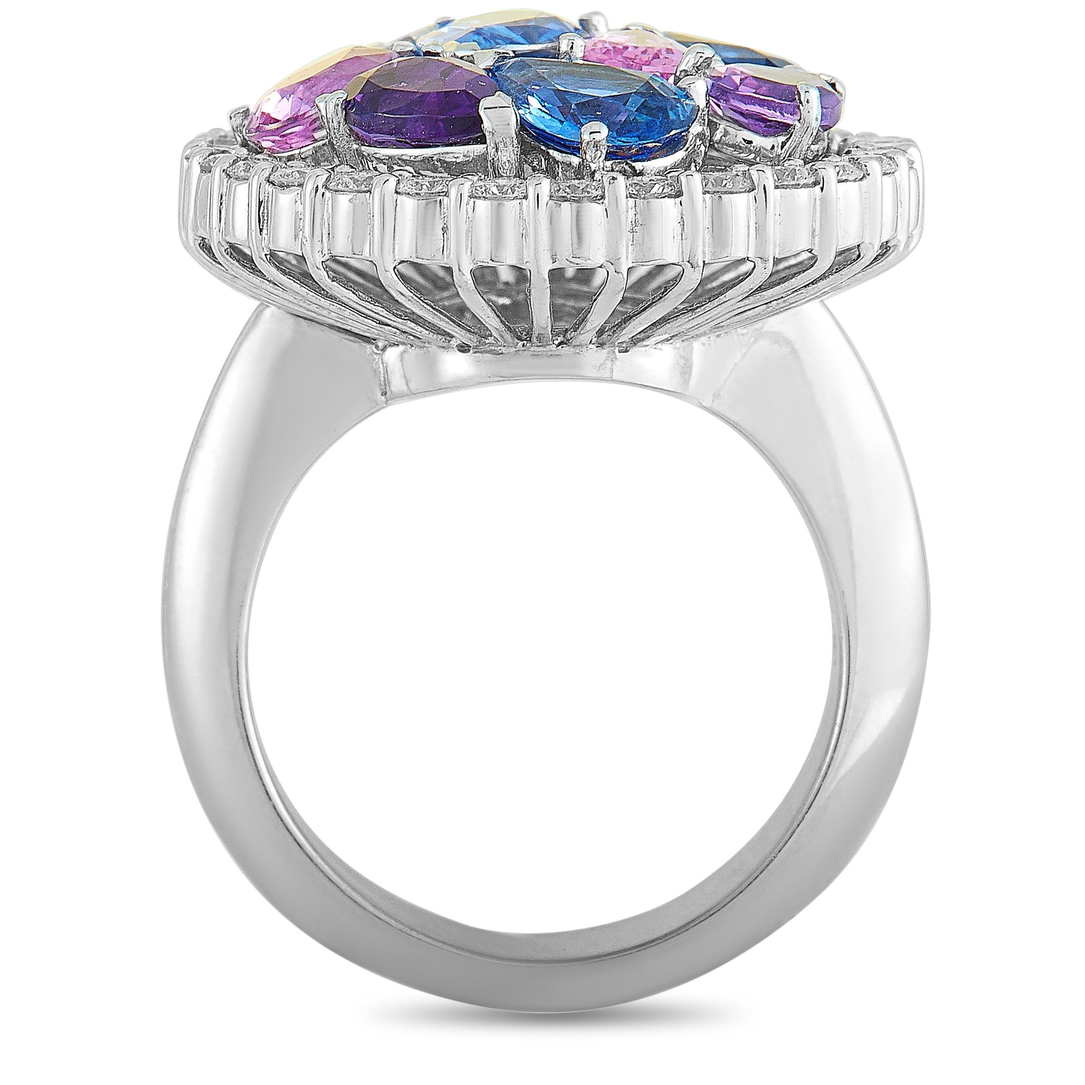 This Roberto Coin ring is crafted from 18K white gold and set with a total of 0.90 carats of diamonds, 1.25 carats of amethysts, 3.23 carats of blue sapphires, and 1.63 carats of pink sapphires. The ring weighs 15.9 grams, boasting band thickness of