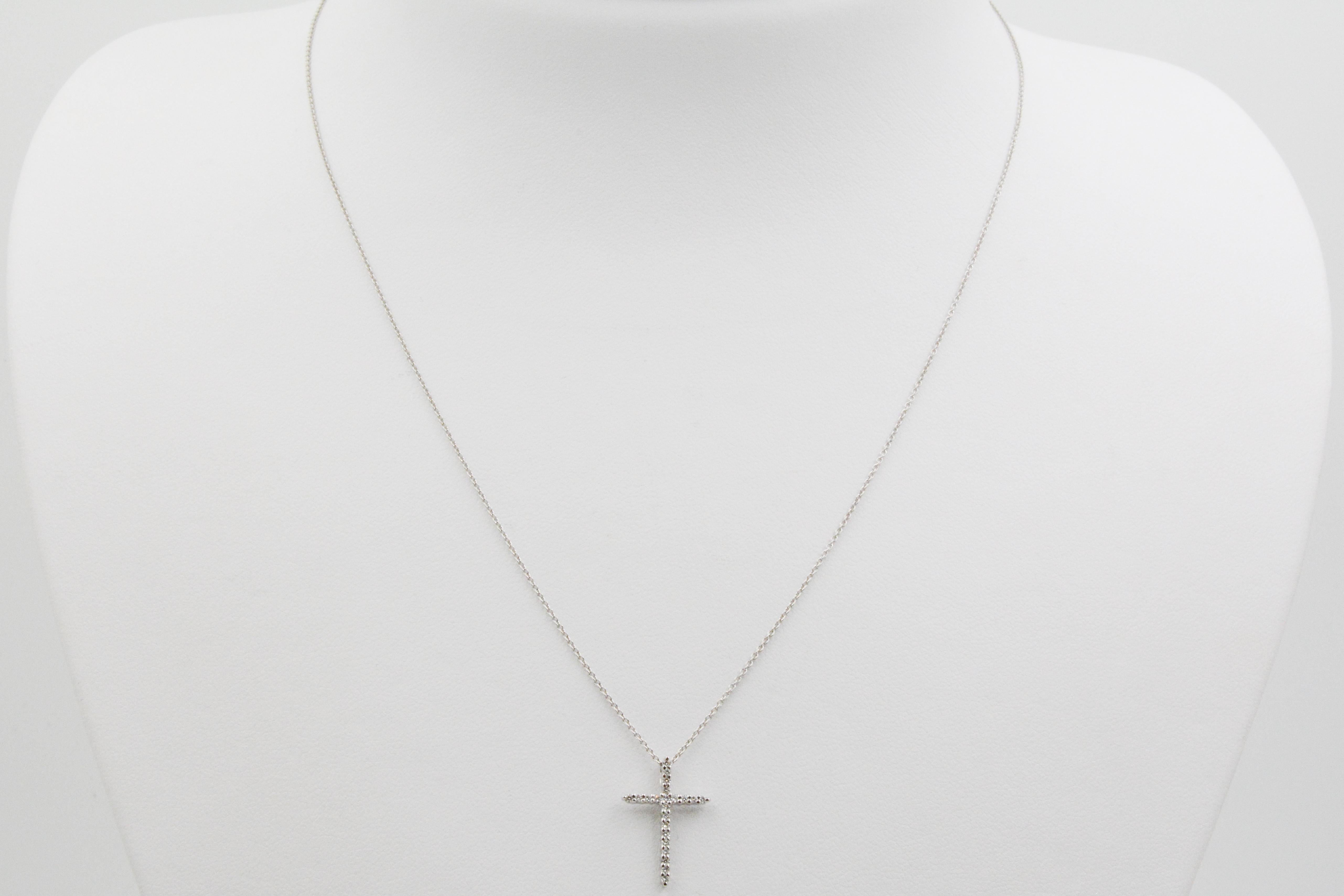 From Roberto Coin, this Tiny Treasures pendant features an 18k white gold and diamond cross, weighing a total of .10 carats. The pendant is on a 16-18” adjustable link chain. The necklace also has the famous Roberto Coin ruby signature on the back. 