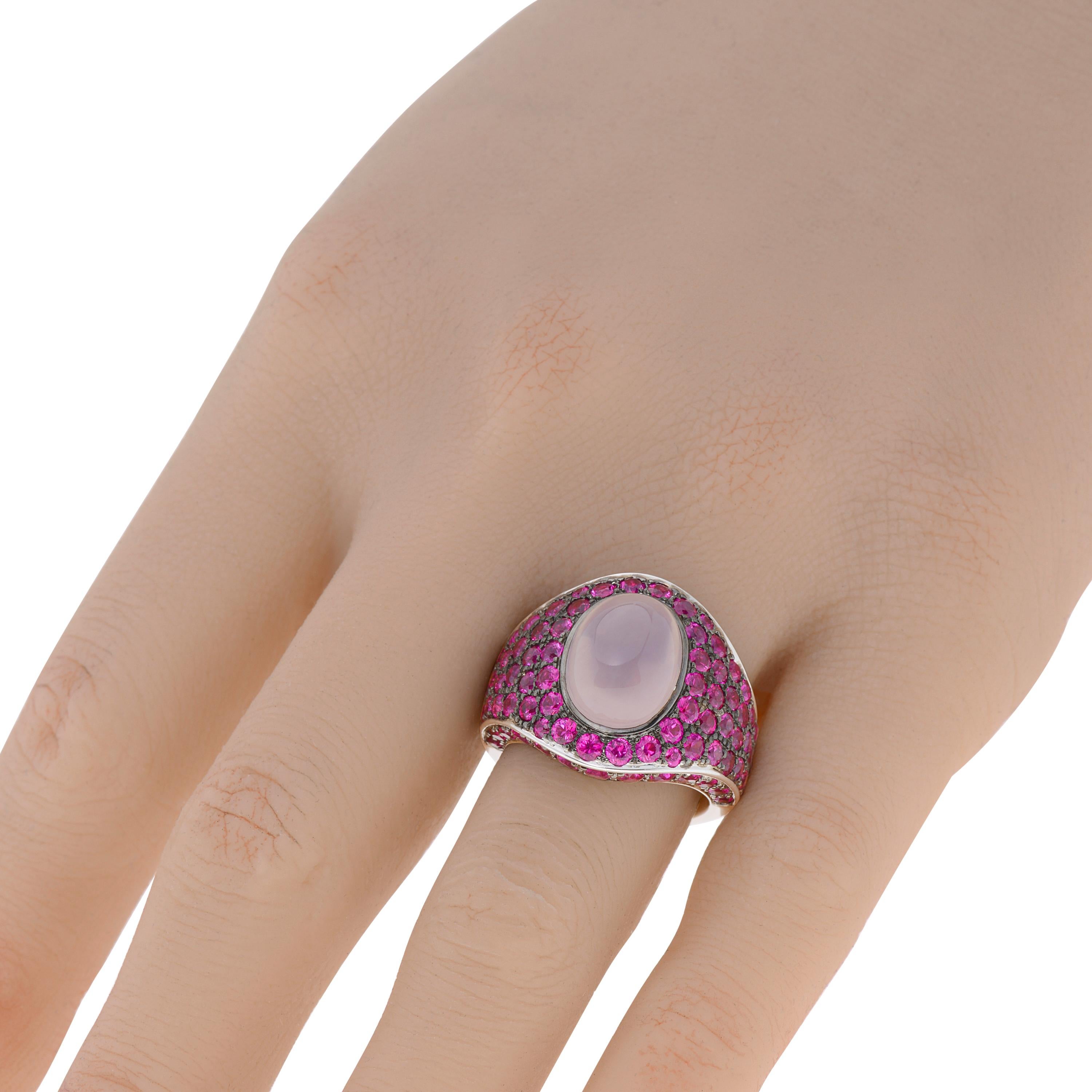 This bejeweled Roberto Coin 18K White Gold Cocktail Ring features a 5.50ct. cabochon pink quartz in perfect harmony with 5.05ct. tw. round cut rubies. The ring size is 7 (54.4). The decoration size is 10mm x 13mm. The weight is 143g.
