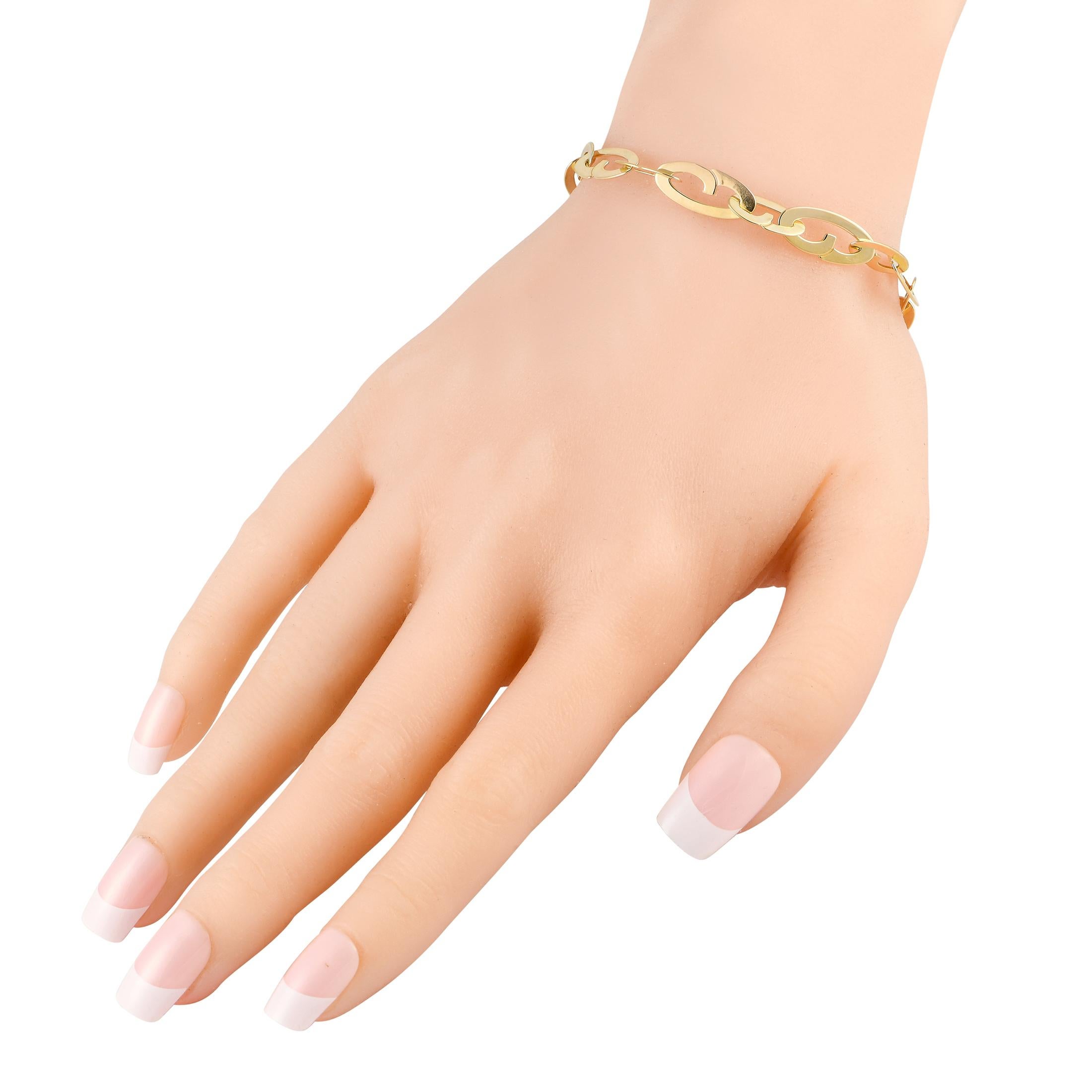 If major bling isn't your thing, then this Roberto Coin creation is for you. The bracelet features a chain of flat links in 18K yellow gold, terminating to a toggle clasp with sapphire embellishment. The understated style of this bracelet wears and
