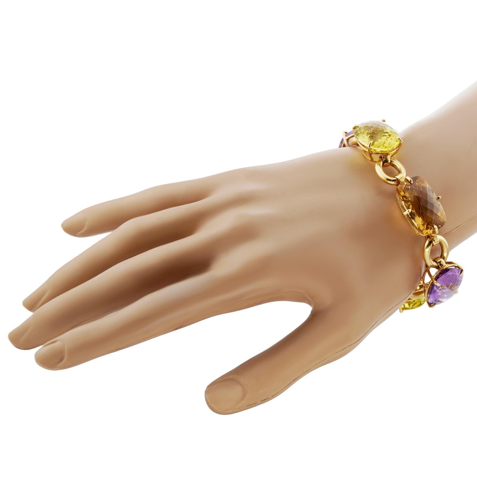 This chic authentic Robert Coin bracelet is crafted in 18k yellow gold and set with vibrant faceted oval gemstones - amethyst, yellow topaz, and lemon citrine. Made in United States circa 2010s. Measurements: 0.66