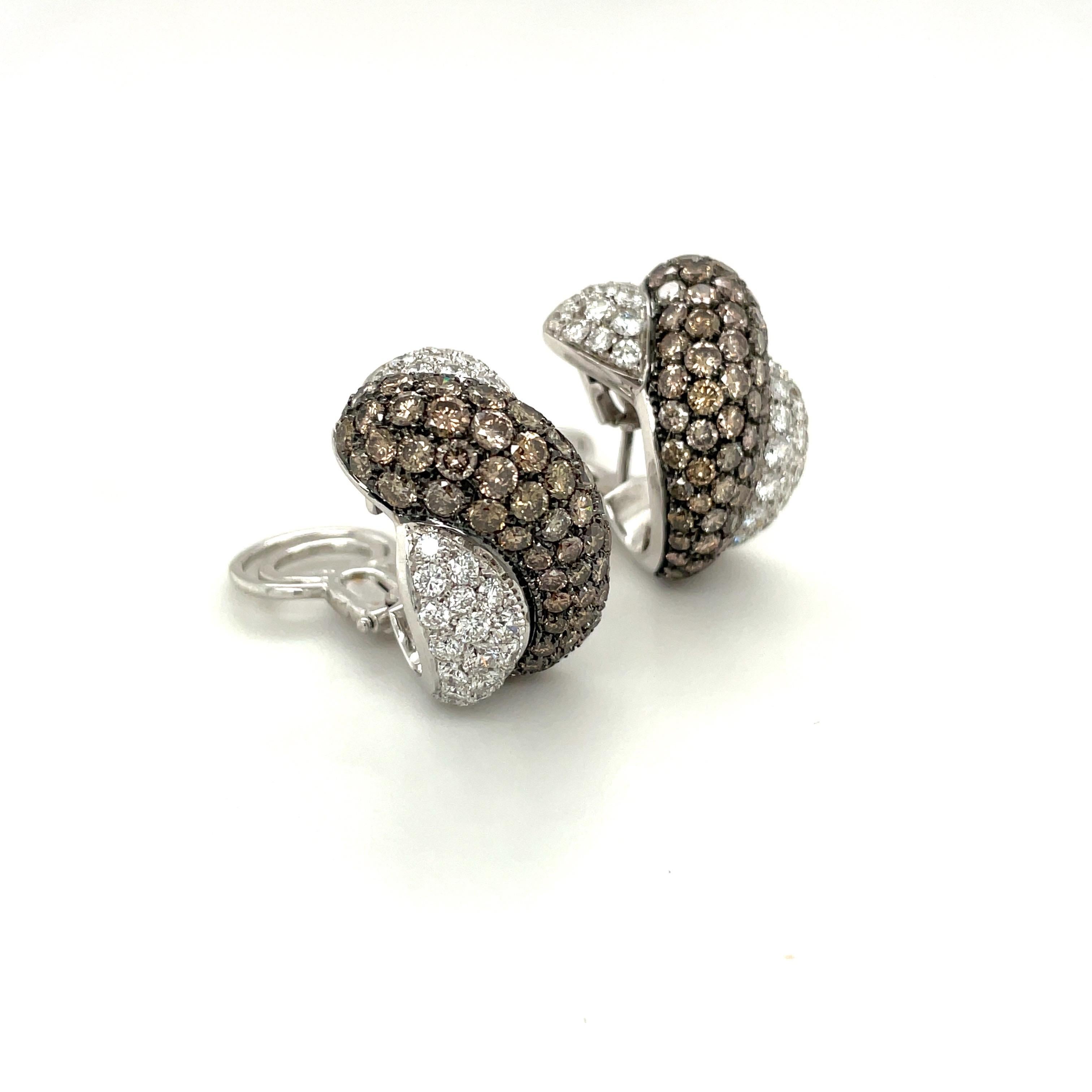Crafted by Roberto Coin of Italy, these 18 karat white gold earrings are real showstoppers. Designed as a half hoop  which has been meticulously pave set with round brilliant brown and white diamonds. The brown diamonds are set in a blackened gold,