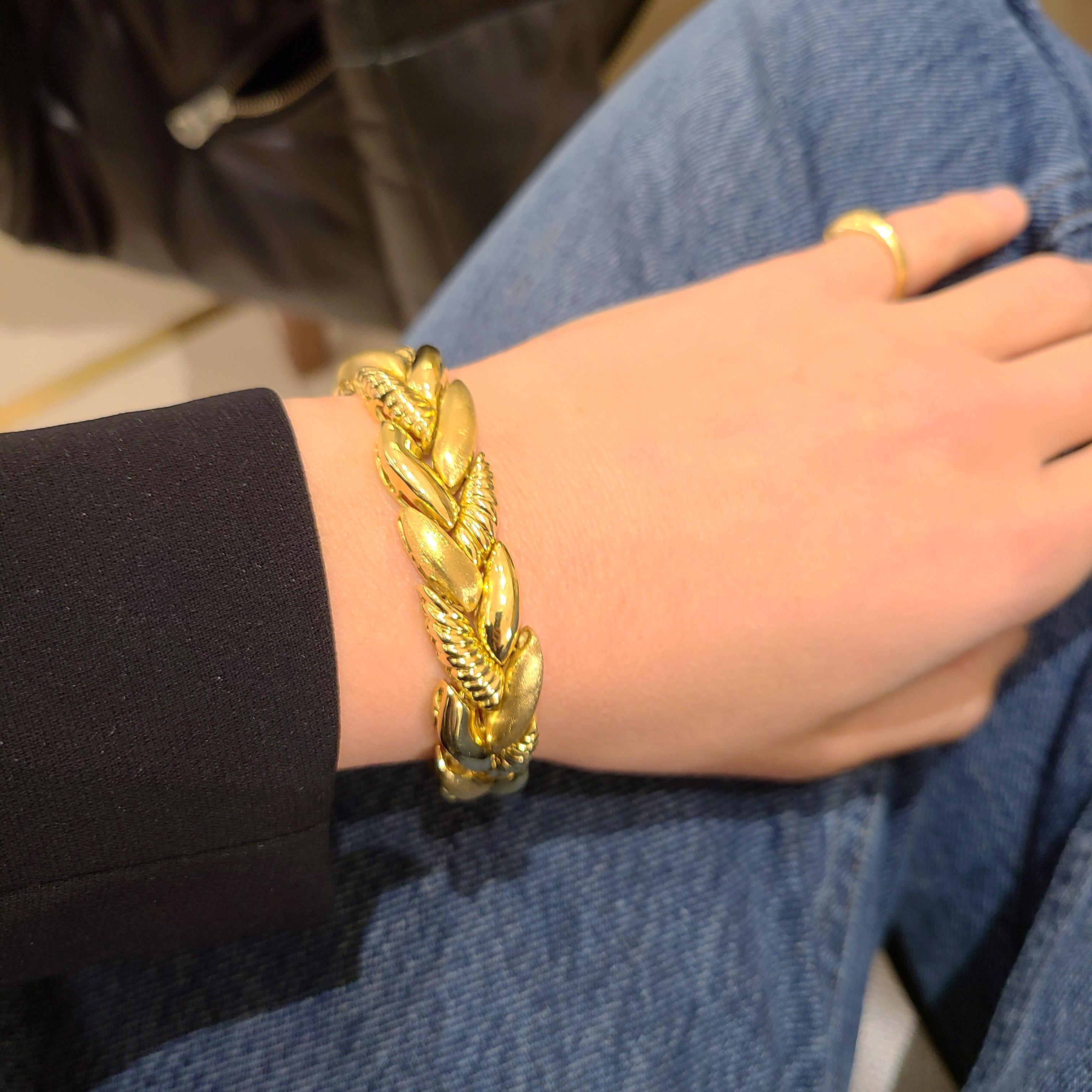 Beautiful 18kt yellow gold bracelet designed by Roberto Coin of Italy. The bracelet is designed as a braid with 3 different finishes, shiny,matte and ribbed. Together the contrast works exquisitely in this classic and timeless  7.25