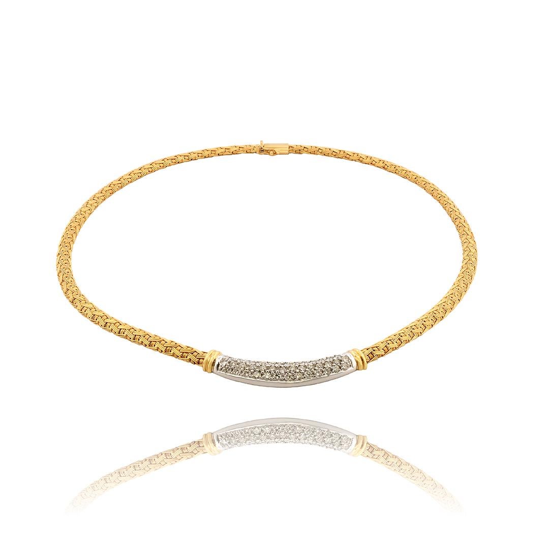 This circa 1980’s 18 karat yellow gold necklace by designer Roberto Coin features a textured basket weave chain with a center bar made of 18 karat white gold that is set with 54 round brilliant cut diamonds that weigh approximately 3.00 carats