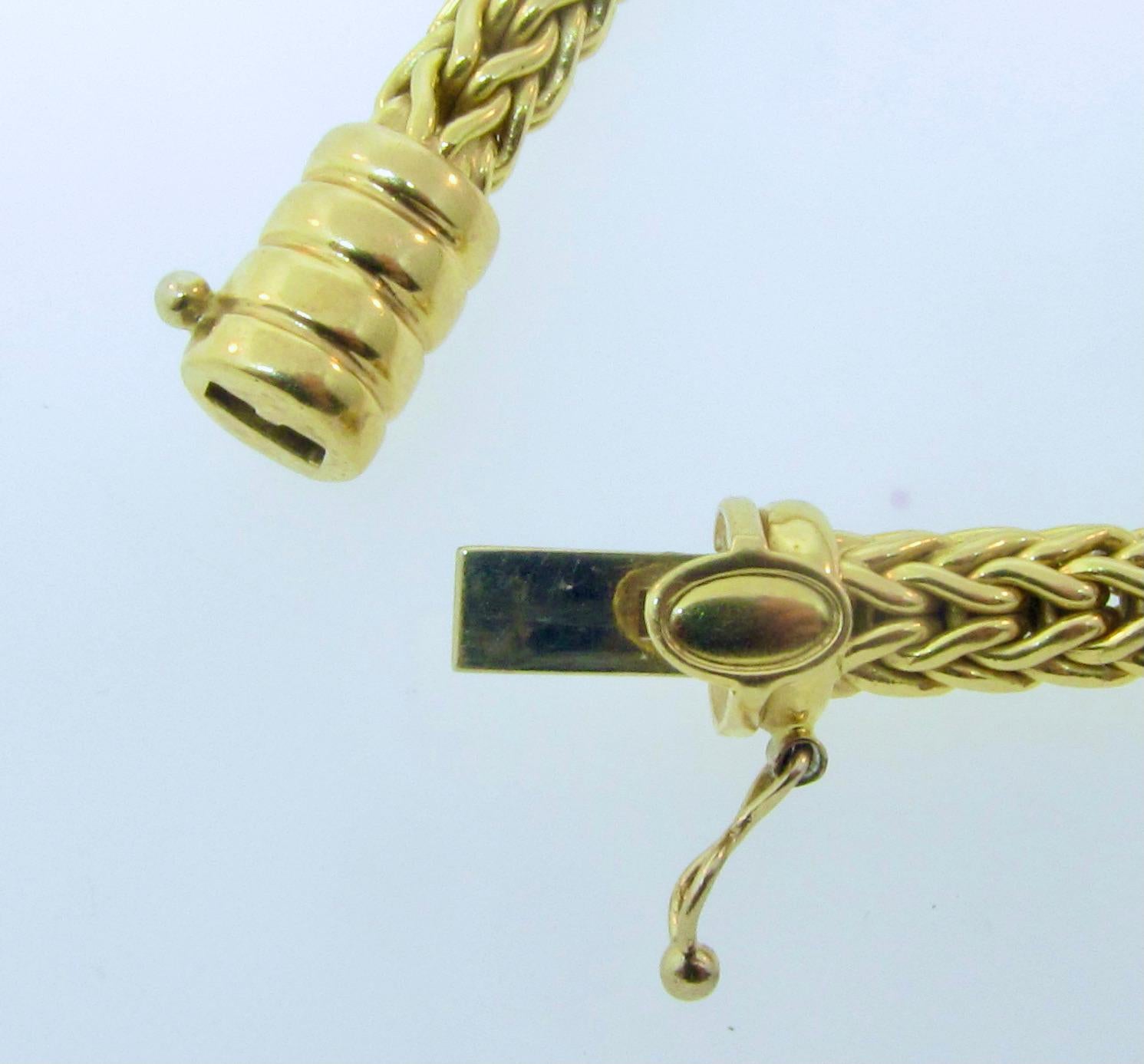 Roberto Coin 18k yellow gold woven necklace. The necklace was most likely produced in the mid 1990's.   34.6 grams, 5mm wide and 16 inches long.  Snap in closing mechanism with a figure 8 secondary clasp.  The necklace is in good condition. 
