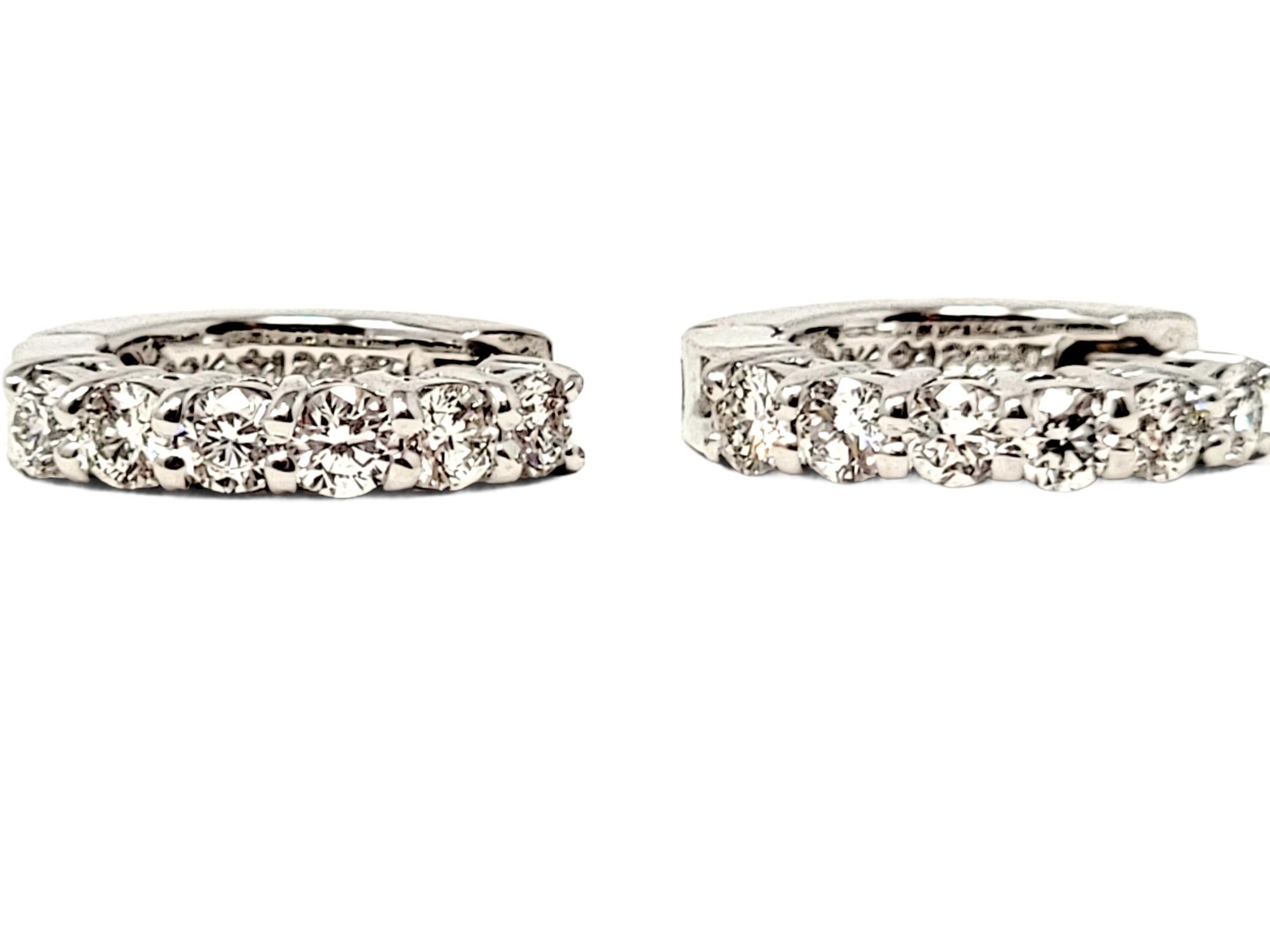 Simple yet stunning 18 karat gold and diamond huggie hoop earrings by jewelry designer, Roberto Coin. These stylish earrings are perfect for any occasion and bring a touch of sophistication to any look. These lovely Roberto Coin earrings each