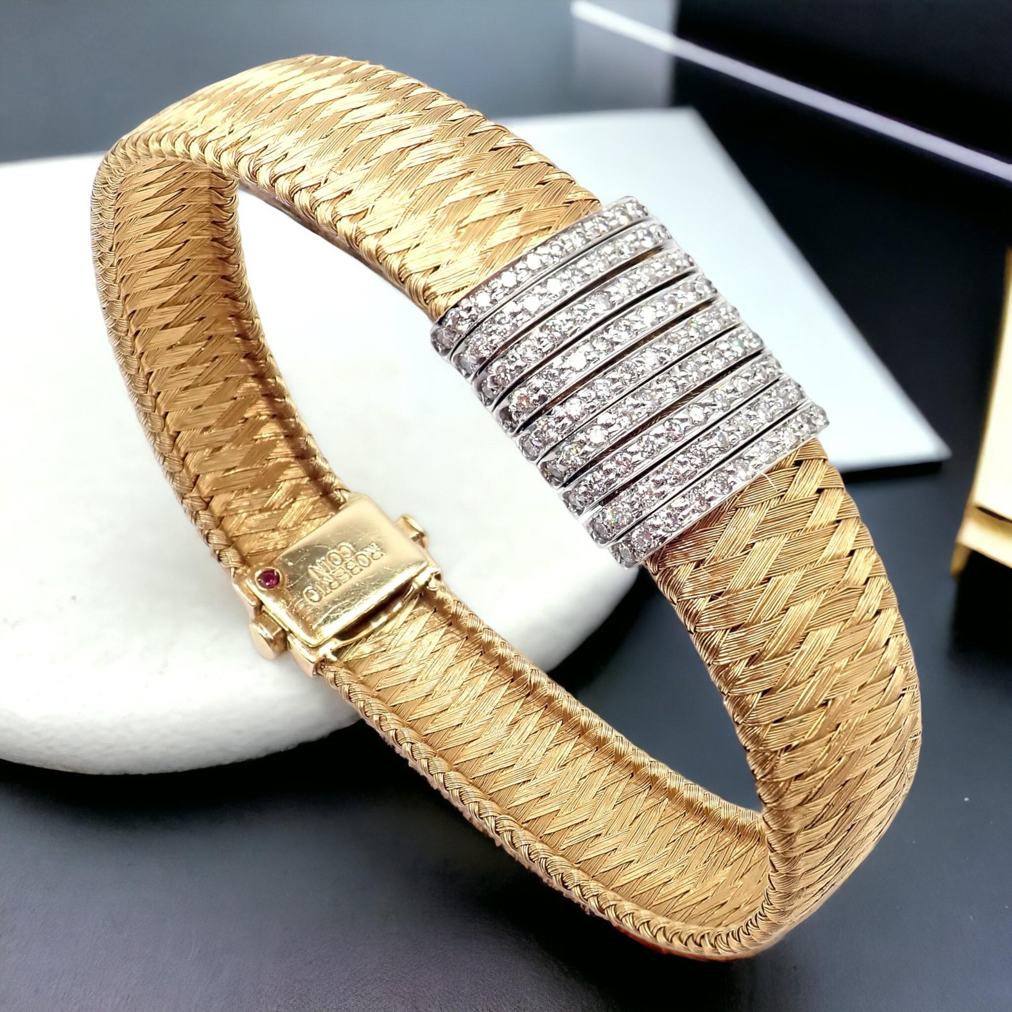 The Roberto Coin 18k Yellow Gold 9 Row Diamond Silk Weave Bracelet is an exquisite piece of jewelry. It features nine rows of diamonds set in 18k white gold bars. These bars are set on a basketweave design to resemble silk, entirely crafted from 18k