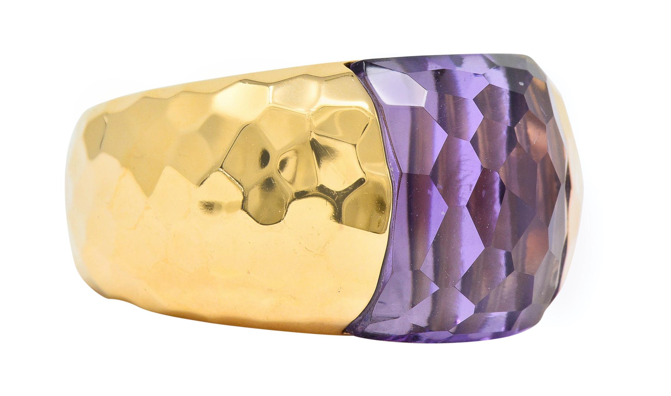Band ring features a strongly hammered finish and a flushly set mixed cut amethyst

Transparent and very light purple in color and measures approximately 12.2 x 12.2 mm

Stamped with Italian assay marks for 18 karat gold

Fully signed Roberto Coin