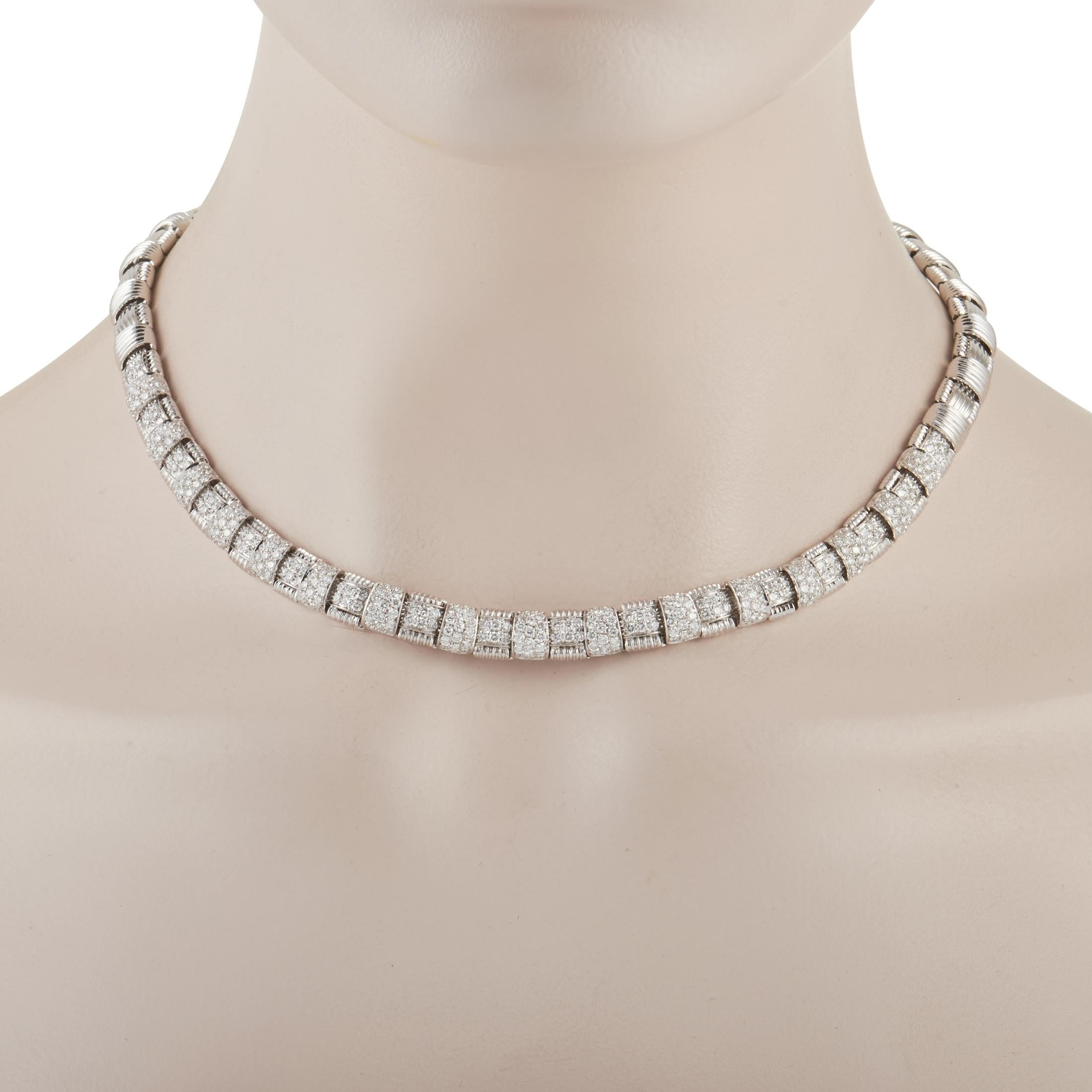 This bold Roberto Coin Appassionata 18K White Gold 7.00 ct Diamond Necklace is made with 18K white gold forming a thick chain of links and set with 7.00 carats round diamonds. The back of the links feature heart cutout on each and are set with a