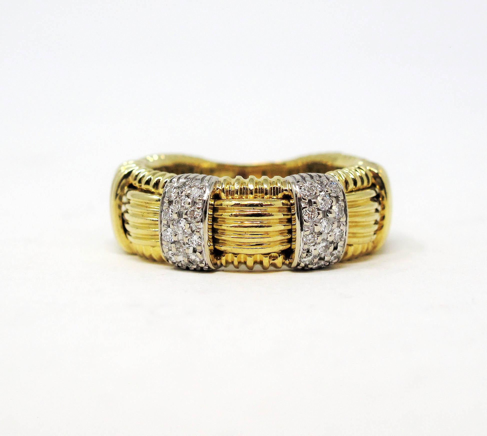 Ring Size: 7

Simple yet stunning 18 karat gold and pave diamond band ring by jewelry designer, Roberto Coin. The striking contrast of the icy white diamonds against the golden hue of the metal allows the diamonds to really pop, while the basket