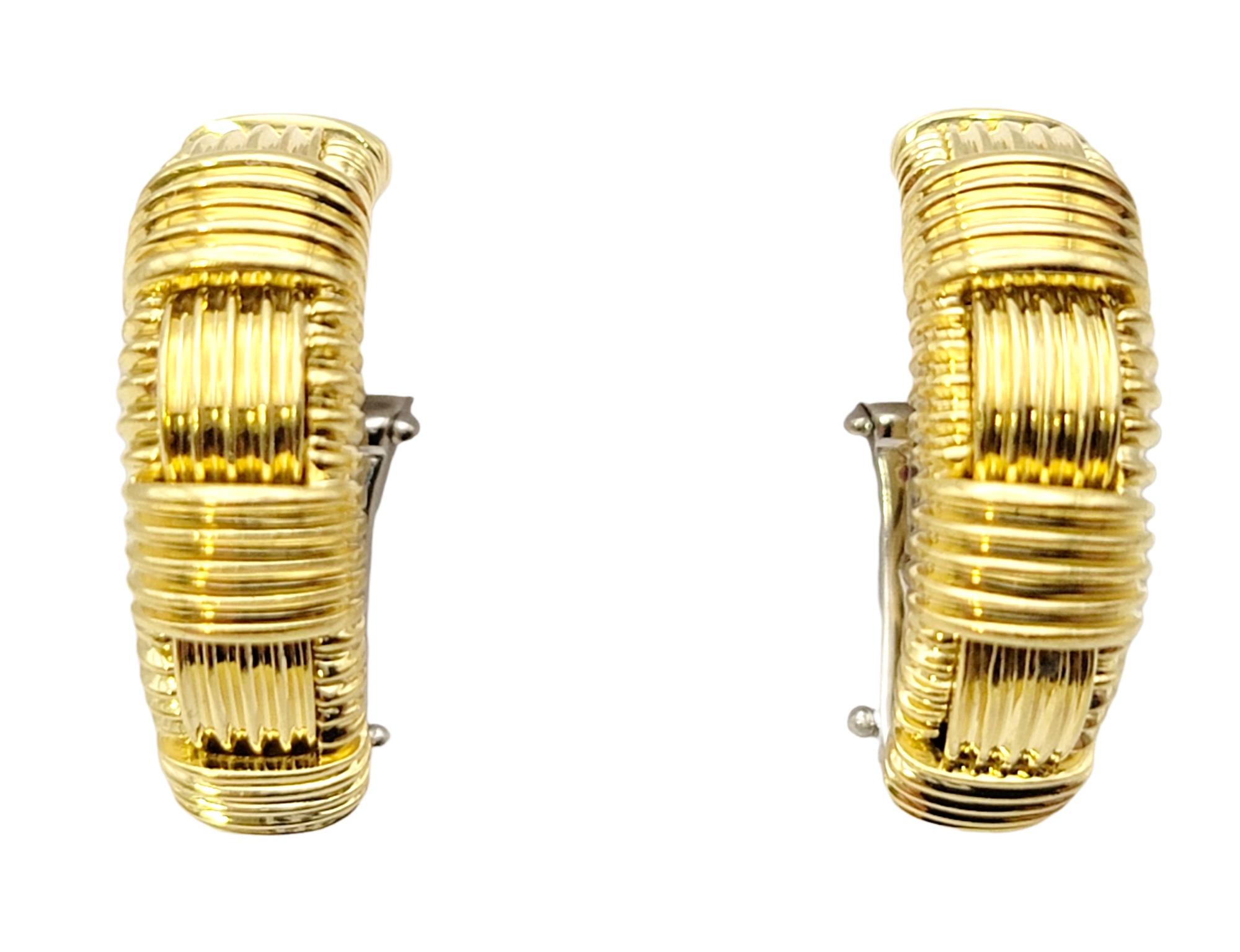 Simple yet stunning half hoop earrings by Italian jewelry designer, Roberto Coin. Part of the Appassionata collection, these earrings feature an 18 karat yellow gold setting with an alternating woven pattern throughout. The rounded shape gently hugs
