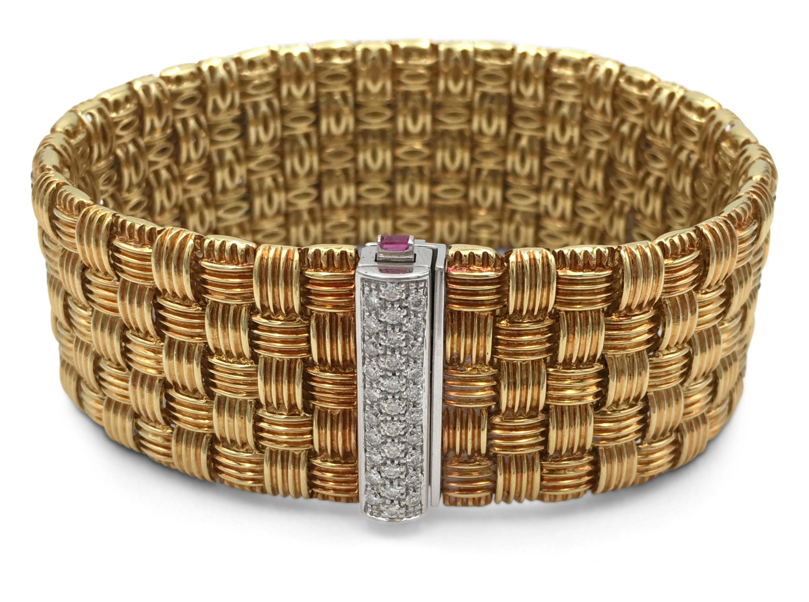 Authentic Roberto Coin 18 karat yellow gold flexible five-row woven look bracelet with a diamond-encrusted clasp from the Appassionata collection. The round brilliant cut diamonds (F-G in color, VS-SI clarity) estimated at 0.30 carats total are set
