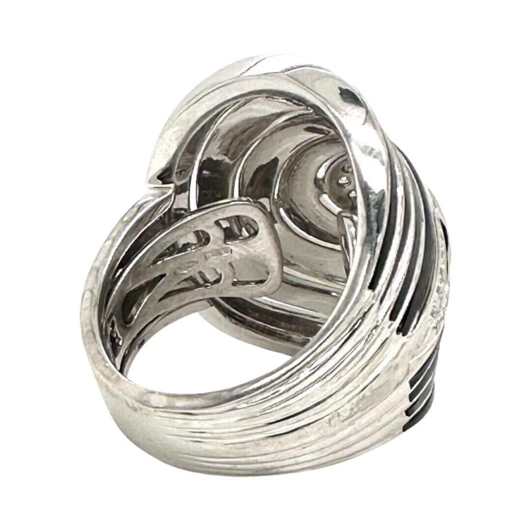 This beautiful Roberto Coin Cocktail Ring is perfect for those seeking a statement piece. It features 0.35ct of round brilliant Cut diamond and it's crafted in 18k white gold and Black Enamel for a gorgeous look. This ring is a size 8 but it's
