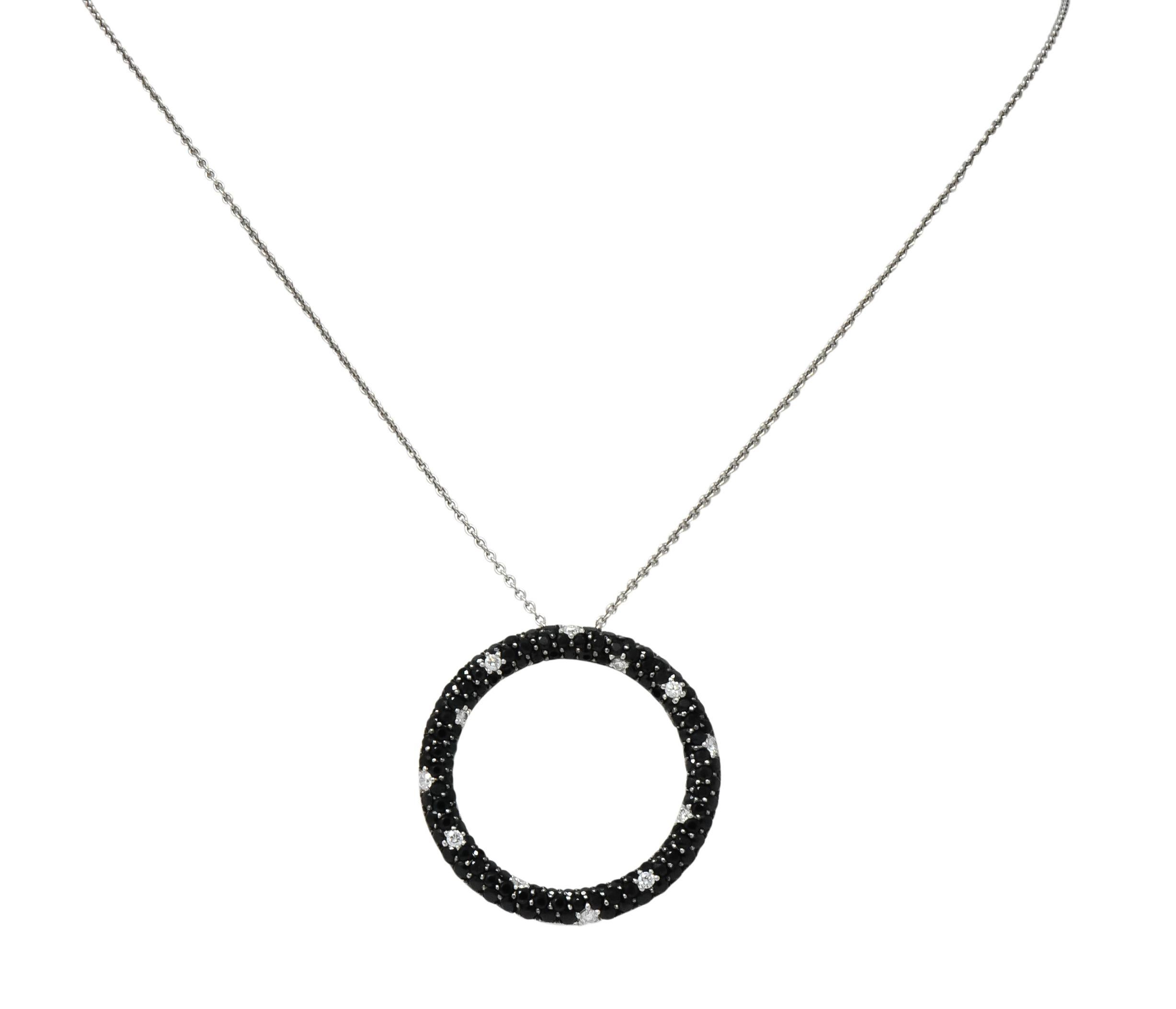 Designed as an open circle with pavé set round brilliant cut diamonds and black sapphires

Twelve diamonds weighing approximately 0.35 carat total, G/H color and VS clarity

One hundred twenty-six black sapphires weighing approximately 4.50 carats