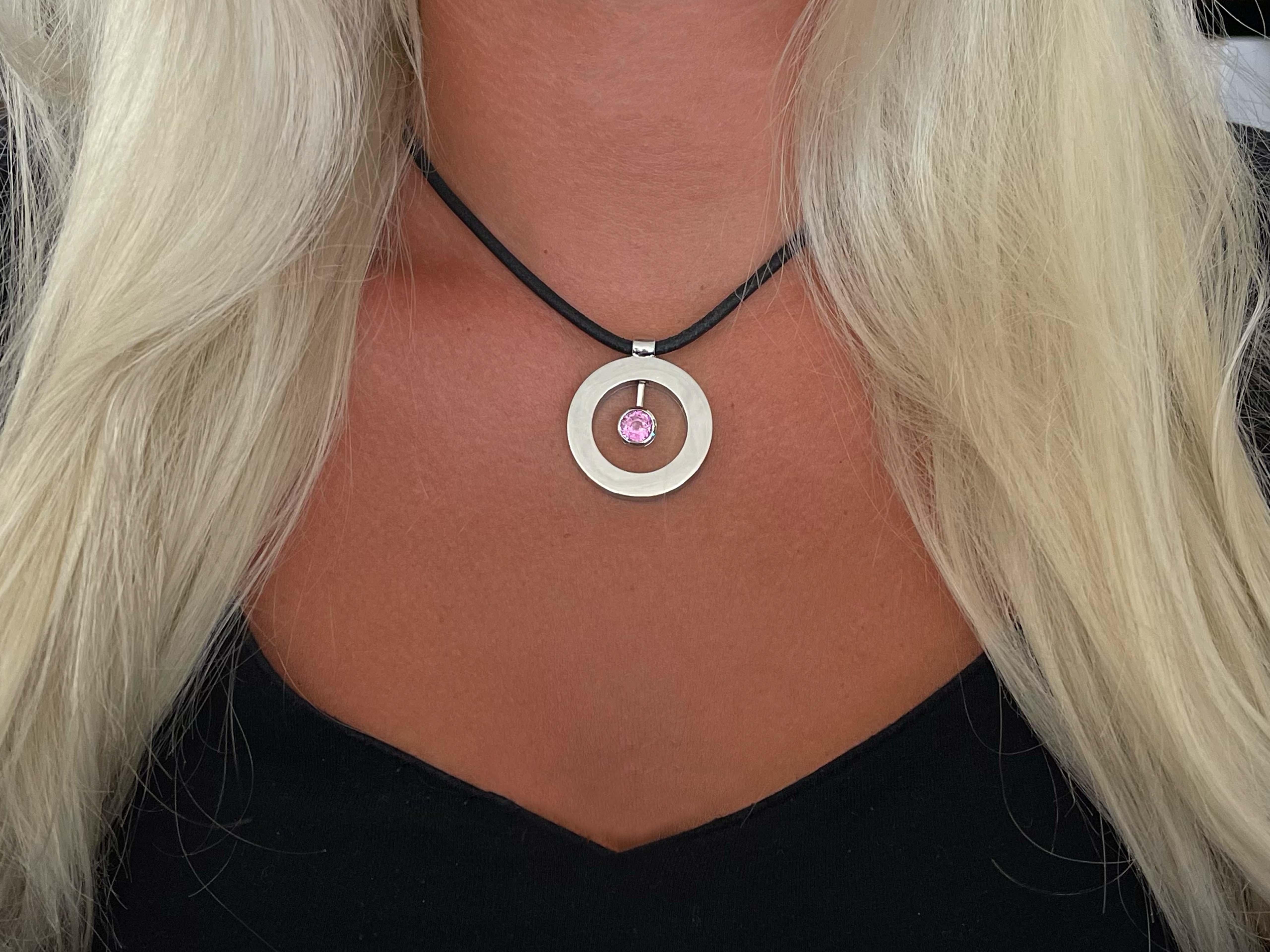 Roberto Coin Cento Pink Sapphire Necklace in 18k White Gold. This stunning cento pendant features a one and a half carat rare pink sapphire. The sapphire is brilliant cut and bezel set. The pendant is  approximately 32 mm in diameter and hangs on a