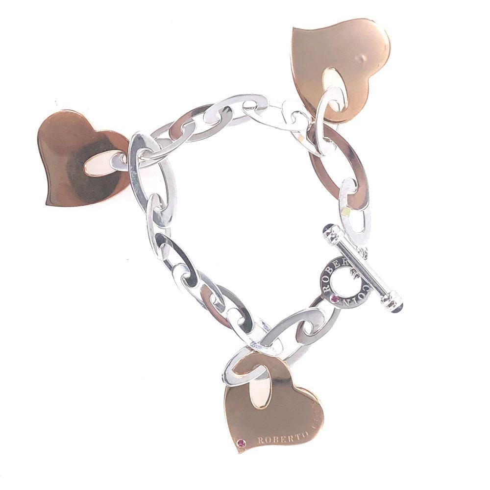 Roberto Coin bracelet from the Chic and Shine collection. The link bracelet is fashioned in 18 karat white gold and features 3 heart charms in 18 karat rose gold. The bracelet measures 7.0 inches in length (7.5 inches with the toggle). Signed and