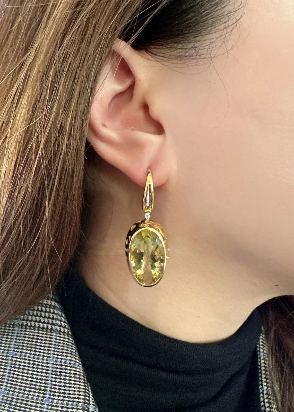 Roberto Coin Citrine & Diamond Drop Earrings in 18k Yellow Gold 

Citrine and Diamond Earrings by Roberto Coin features large Faceted Oval Yellow Citrines in bezel setting with a single Round Diamond atop, all set in 18k Yellow Gold. The earrings