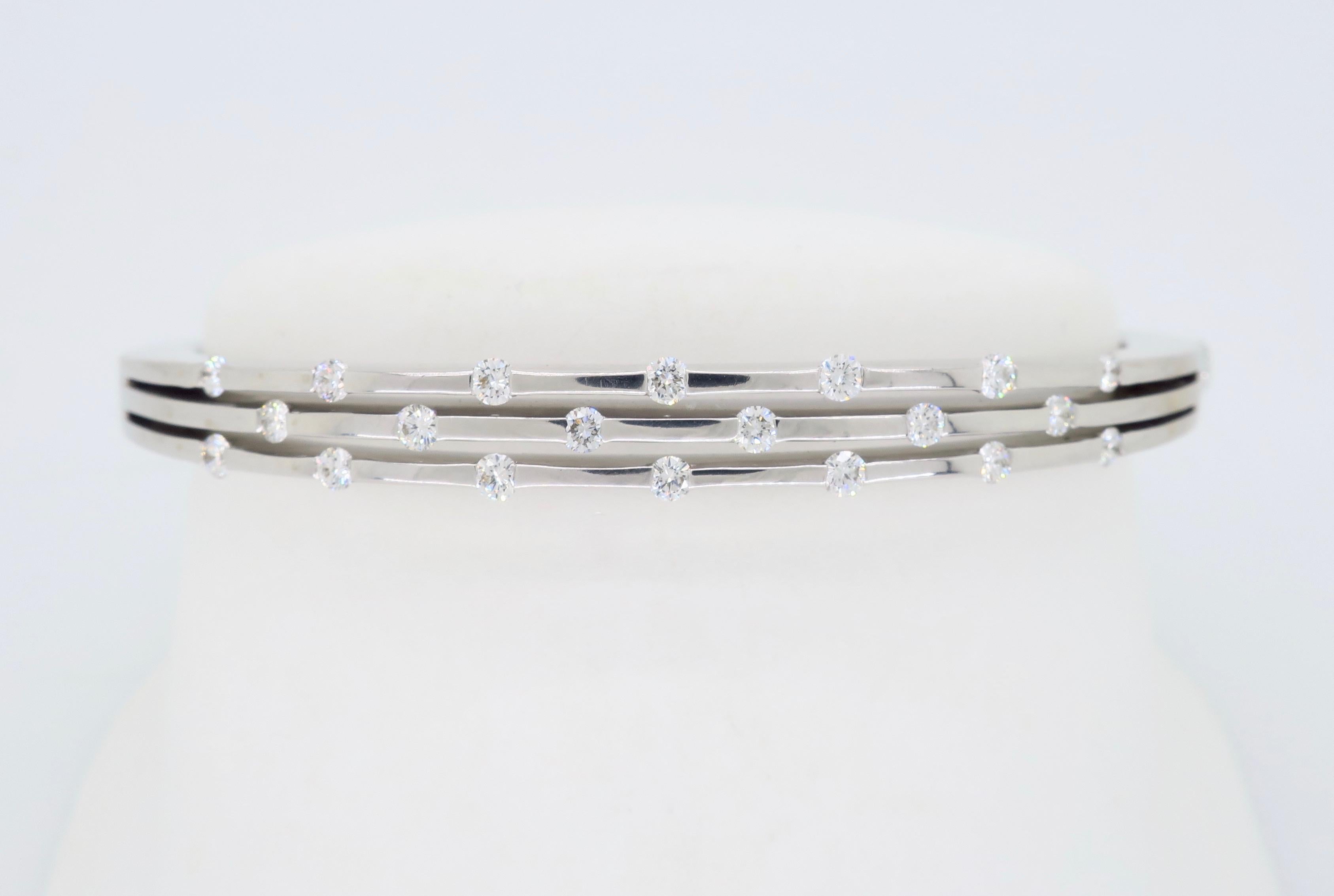 18K white gold Classica Parisienne diamond bangle crafted by designer Roberto Coin.

Designer: Roberto Coin
Diamond Carat Weight: Approximately .65CTW
Diamond Cut: Round Brilliant Cut 
Color: Average G-H
Clarity: Average VS
Metal: 18K White