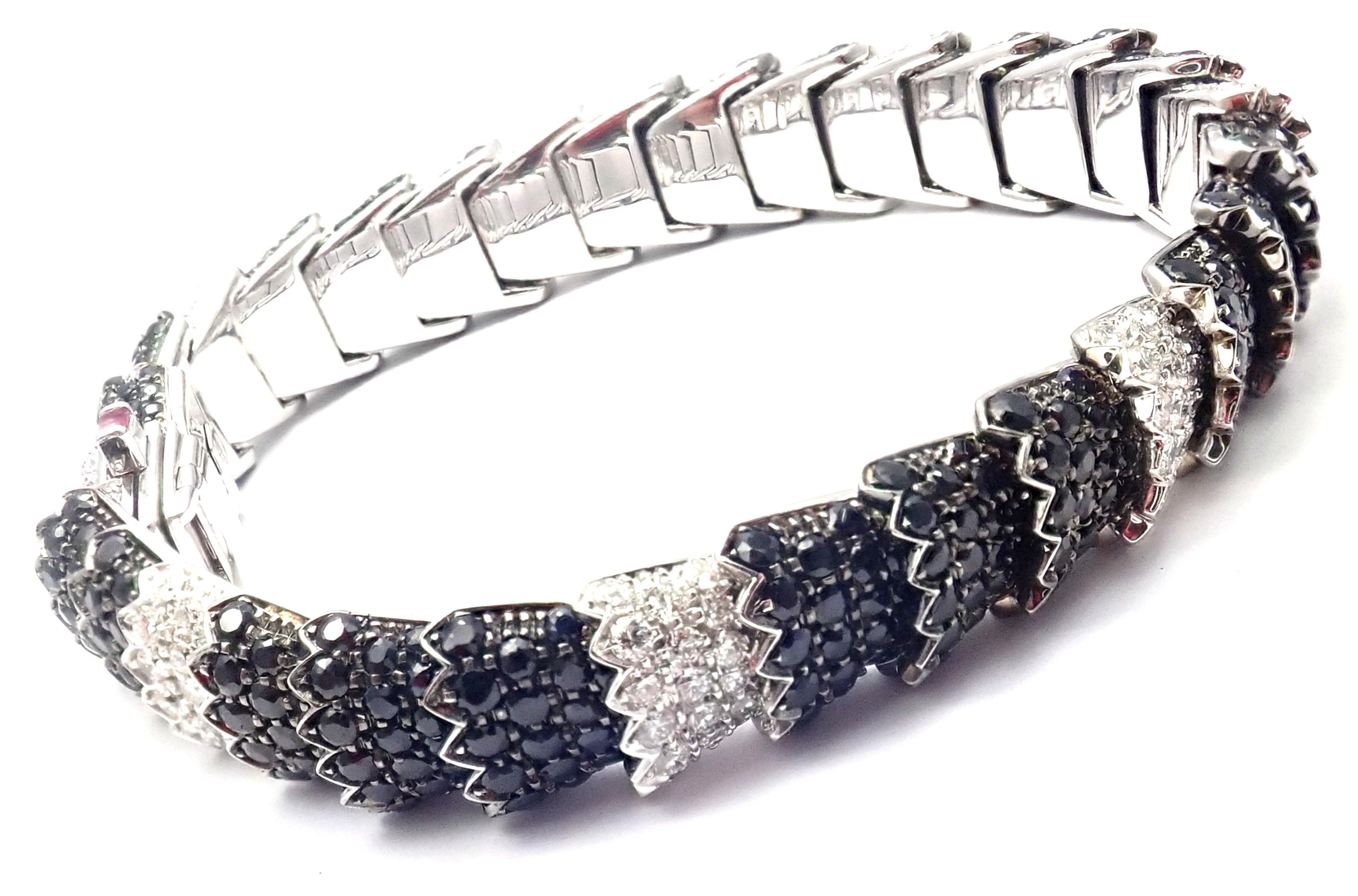 18k White Gold Diamond Black Sapphire Cobra Bracelet by Roberto Coin. 
With 198 round brilliant cut diamonds VS1 clarity, G color total weight approx. 5ct
528 black sapphires total weight approx. 13ct
1 Ruby
Details:
Weight:  46.2 grams
Length: 