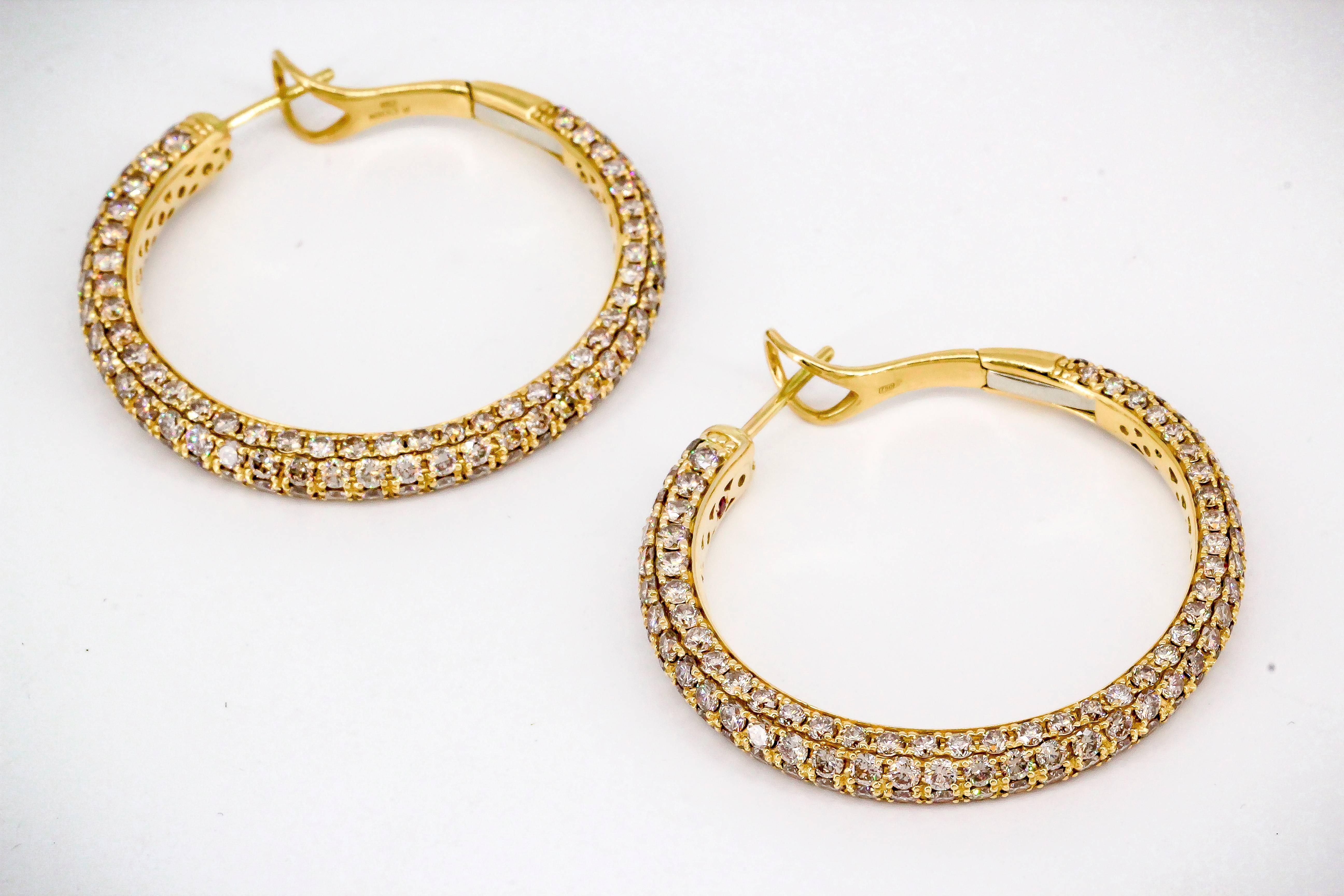 Classic diamond and 18K yellow gold hoop earrings by R. Coin. They feature high grade round brilliant cut colored and white diamonds throughout, approx 9-10 carats total weight.  Diameter approx. 1.5 inch. 

Hallmarks: R. Coin, 750.