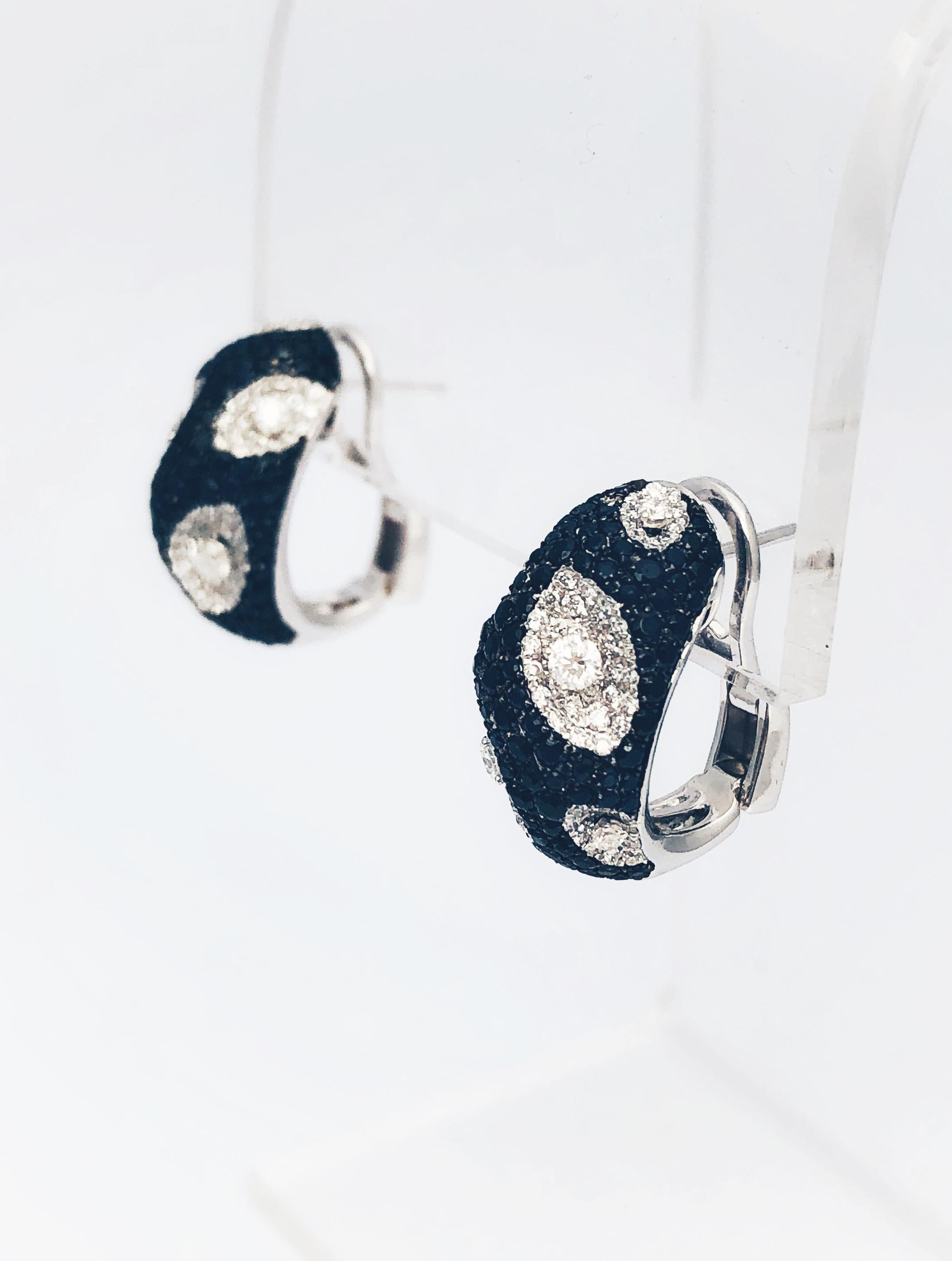 Gorgeous Roberto Coin Diamond and Black Sapphire Huggie earrings. The retail price on this pair is $7300. This pair boasts approximately 1.30 total carat weight of beautiful, pave set,  white diamonds and approximately 2.41 carats of pave set, black
