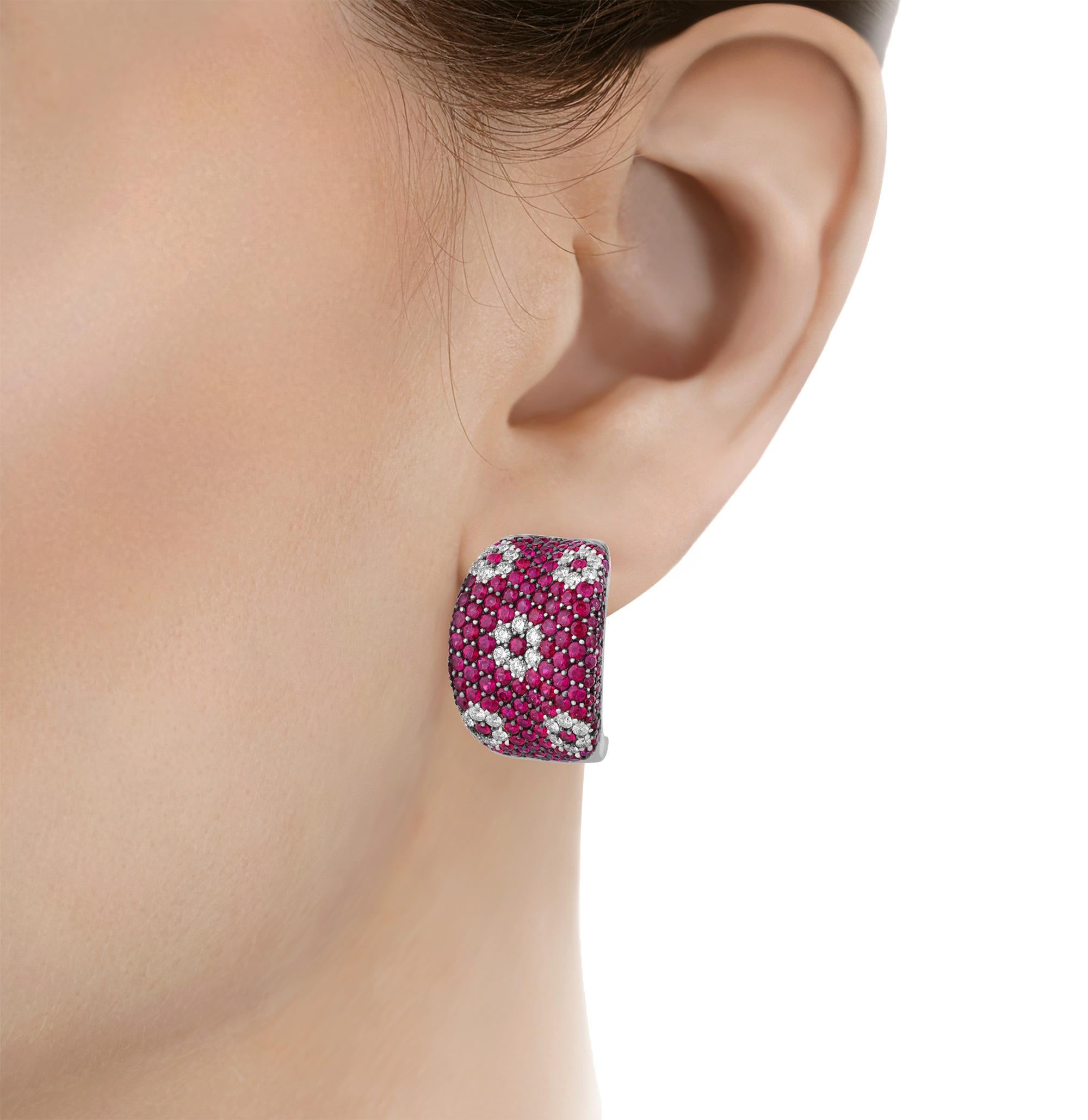 A captivating blend of bold design and exquisite craftsmanship, these Roberto Coin earrings feature an intricate geometric floral motif. The pavé set rubies, totaling 6.00 carats, showcase a vibrant pink hue that beautifully complements the dazzling