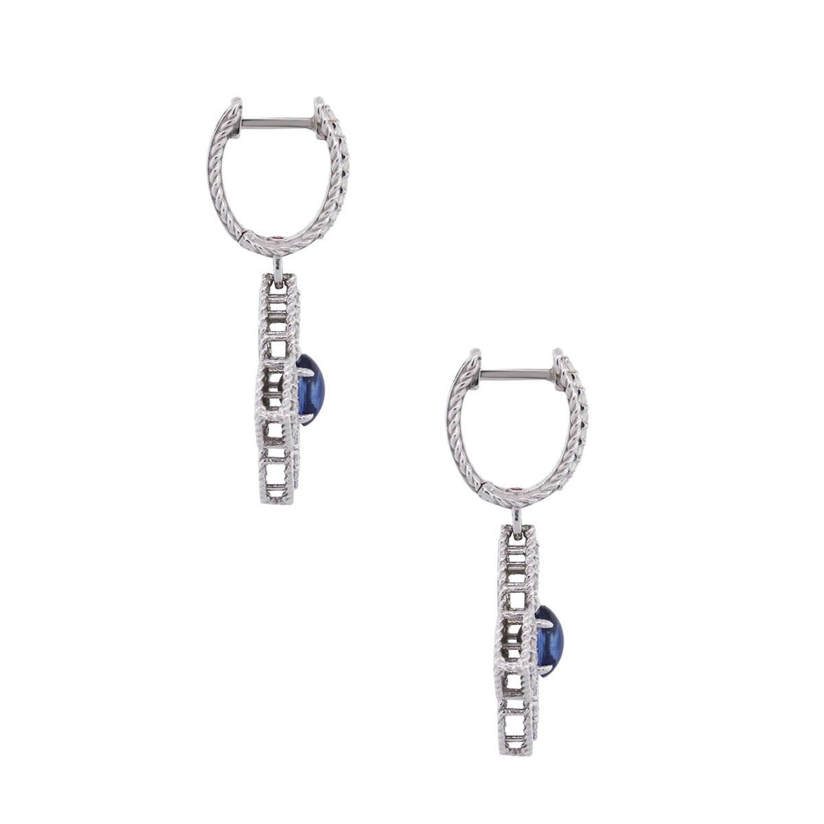 Designer: Roberto Coin
Material: 18k white gold
Diamond Details: 1.04ctw of round brilliant diamonds. Diamonds are G in color, VS in clarity
Gemstone Details: Oval shape cabochon sapphires measuring approximately 5.77mm x 3.40mm each
Earring