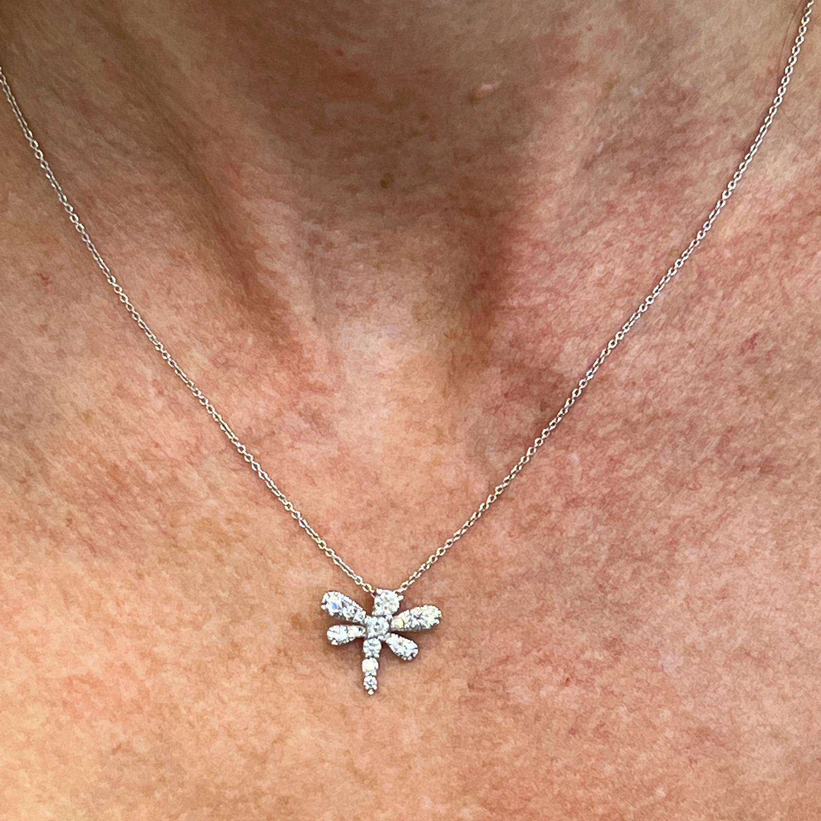 Diamond dragonfly pendant, by Roberto Coin's Tiny Treasure collection, is fashioned in 18 karat white gold. The pendant features 15 round brilliant cut diamonds weighing .44 carat total weight. The pendant measures 15 x 15mm and the chain can be