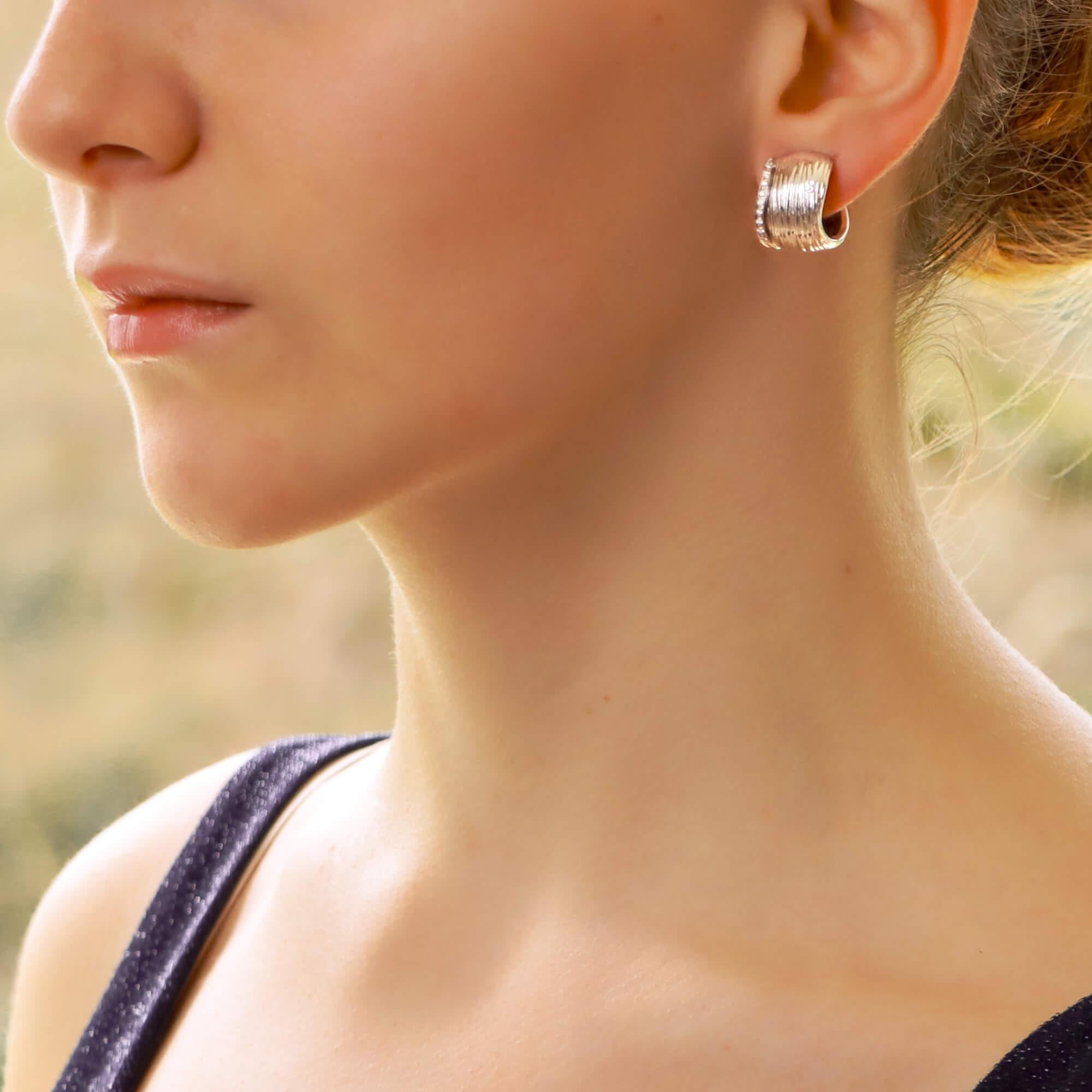 A beautiful pair of Roberto Coin diamond elephant hoop earrings set in 18k white gold.

From the now discontinued 'Elephant Skin' collection, these hoops depicts the feet of an elephant with the base of the foot being millegrain set with 11 round