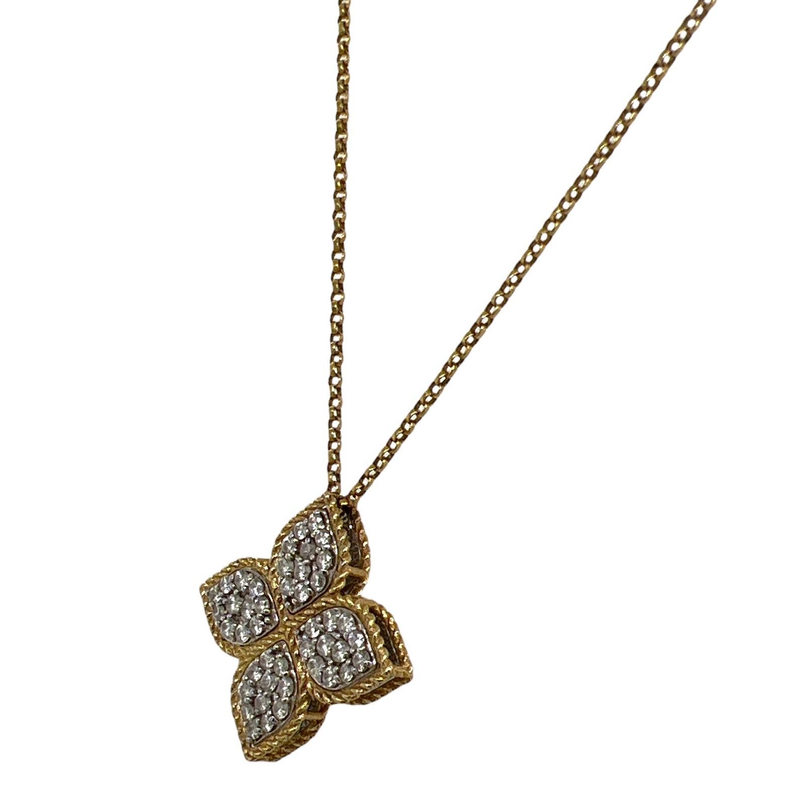 Roberto Coin large diamond flower pendant fashioned in 18 karat yellow gold. The pendant features round brilliant cut diamonds weighing .45 carat total weight and graded F-G color and VS clarity. The pendant measures .75 inches in length and the