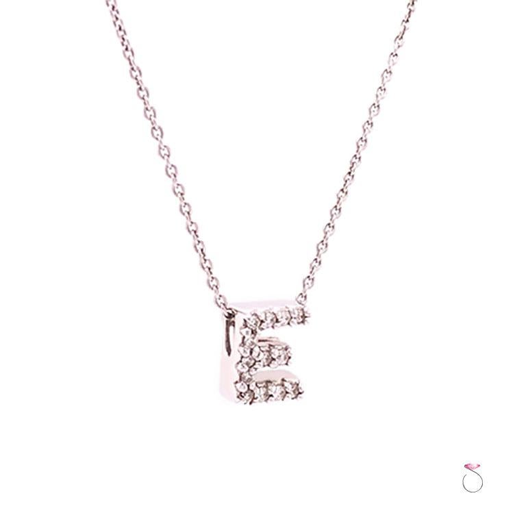 Roberto Coin diamond letter E necklace in 18k white gold. This beautiful letter E pendant is part of Roberto Coin Tiny Treasures collection. The pendant is pave' set with 13 round brilliant diamonds totaling 0.06 carat. As with all Roberto Coin