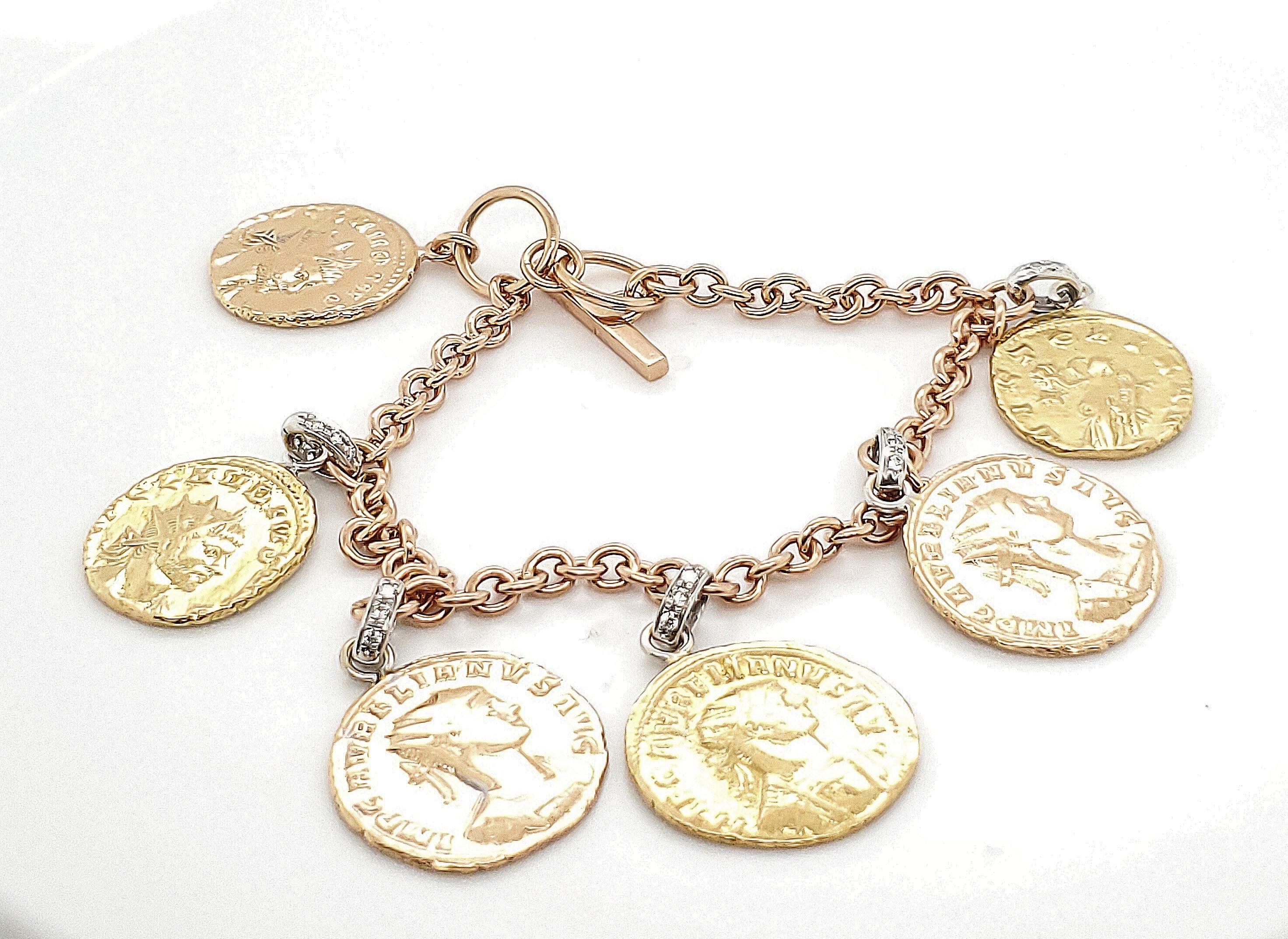 Authentic Roberto Coin charm bracelet crafted in tri-color 18 karat gold. Gold charms are set with approx. 0.30 carats of round brilliant cut diamonds (G color, VS clarity). Signed Roberto Coin 18K Italy. Roberto Coin signature ruby stone. Bracelet