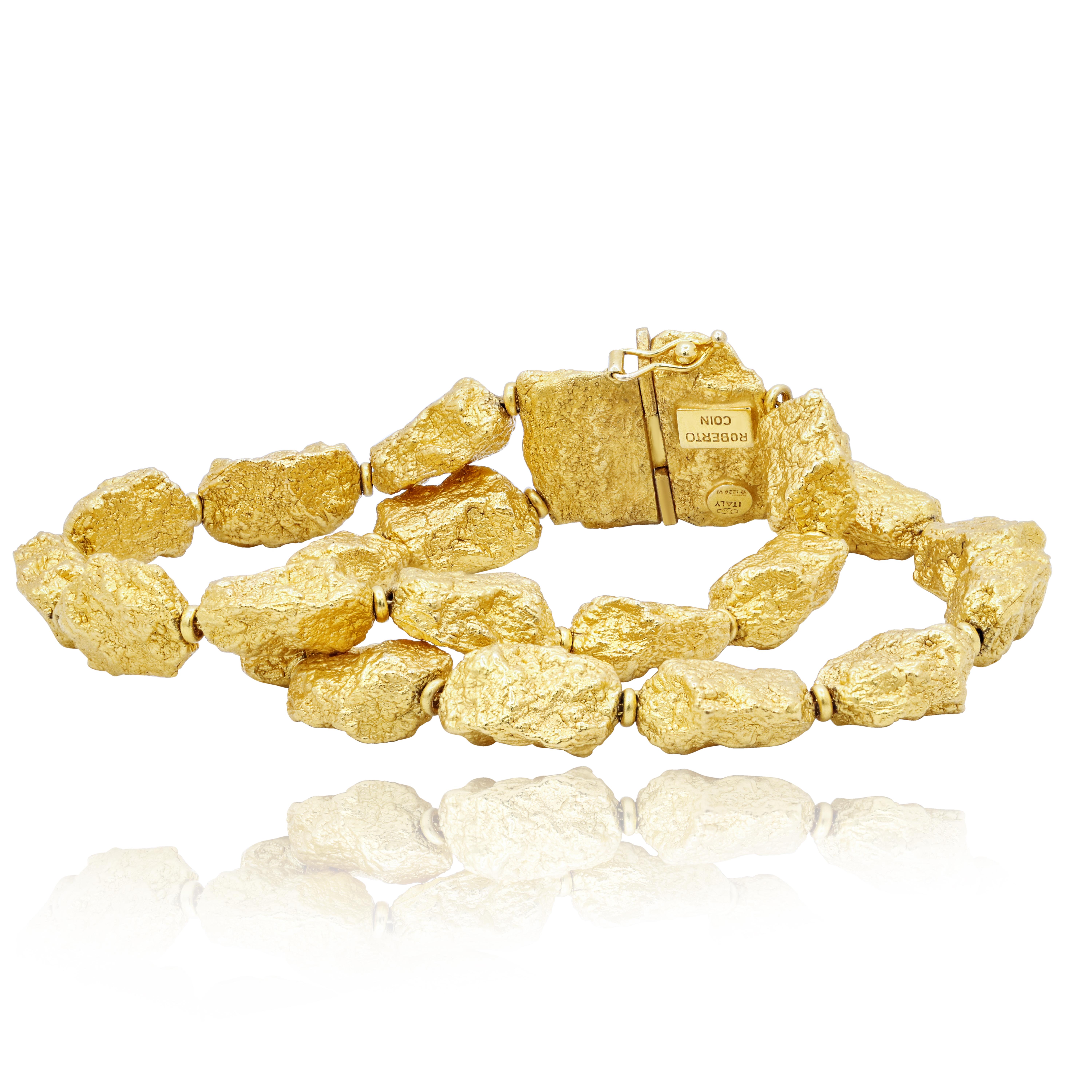 Roberto Coin fancy bracelet comprised of 18ct yellow gold hollow links that are fashioned in the shapes of gold nuggets.

This product will be packaged in a custom box

Composition:
18K yellow gold
Weight: 45.7g

Warranty
Limited lifetime