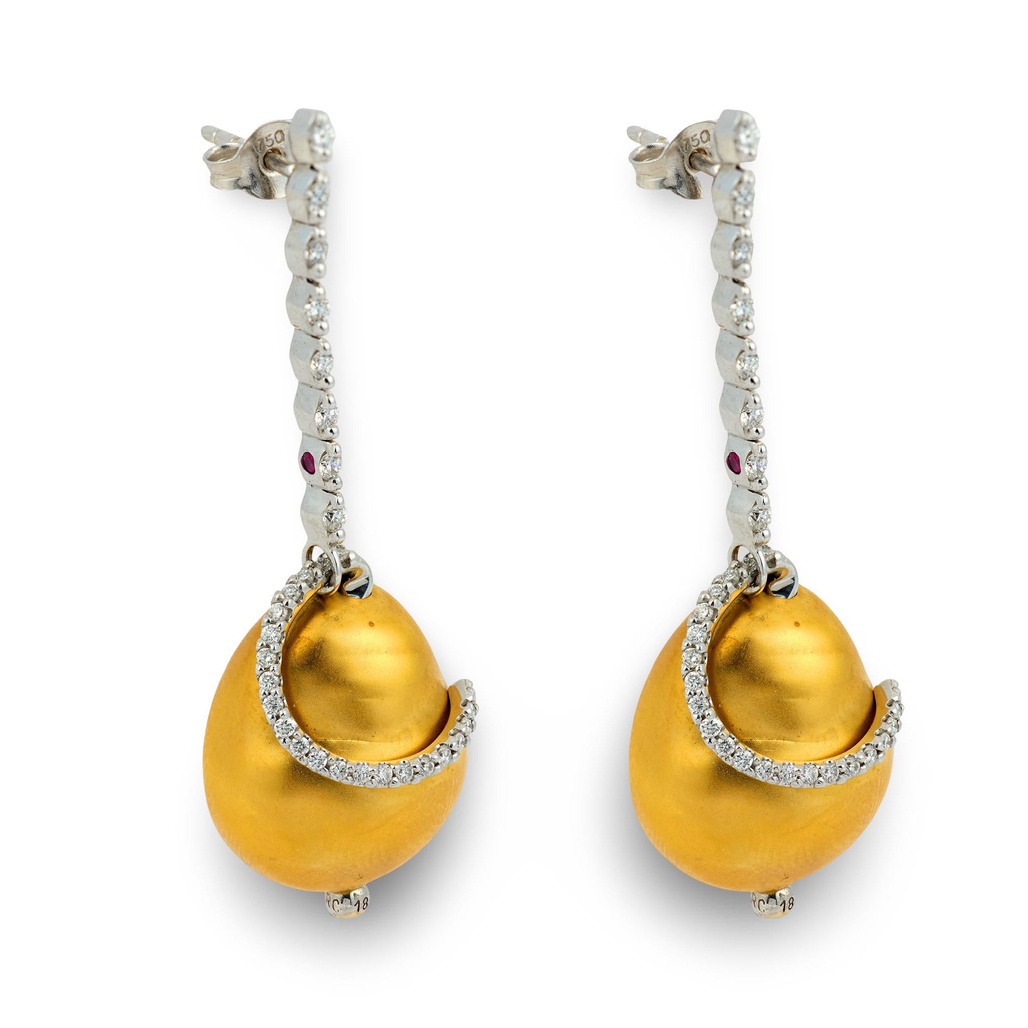 A lovely pair of earrings by legendary jeweler, Roberto Coin! Crafted in 18k white gold, each earring begins with a long, vertical row of 8 modern round brilliant cut diamonds. All of the diamonds are held within two-prong settings.The side of the