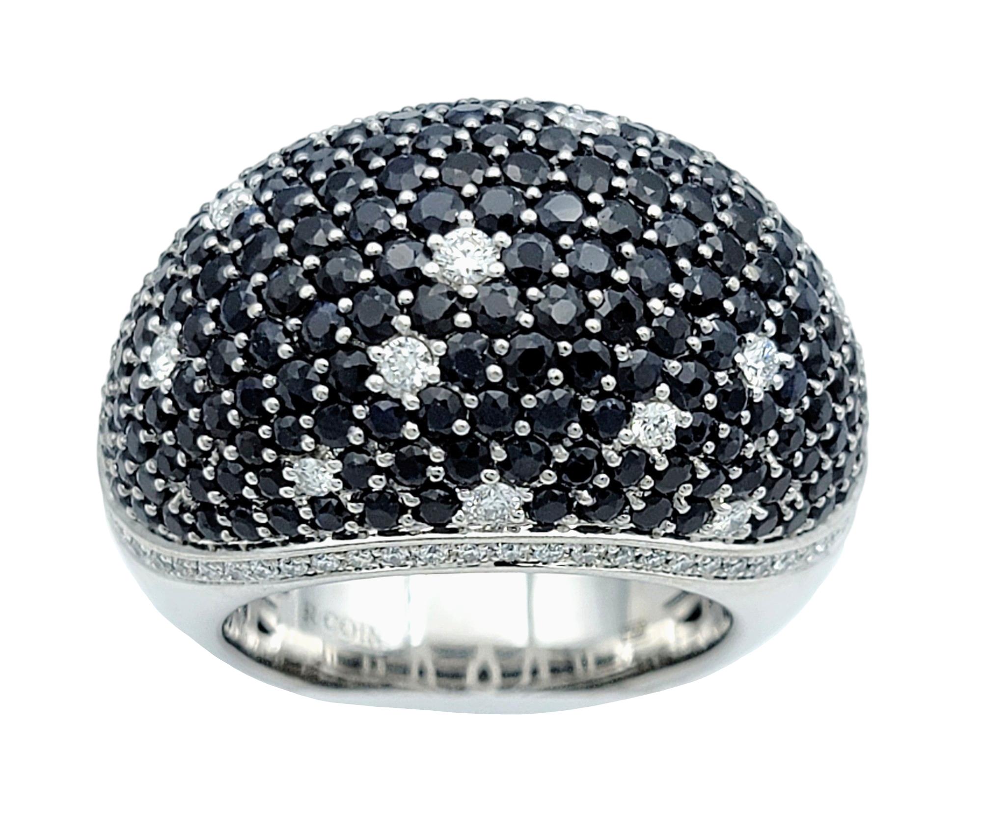 Ring Size: 7.5

This Roberto Coin Fantasia dome ring exudes luxury and sophistication with its captivating design. Crafted in 18 karat white gold, the ring features a stunning array of vibrant blue sapphires and dazzling diamonds arranged in a