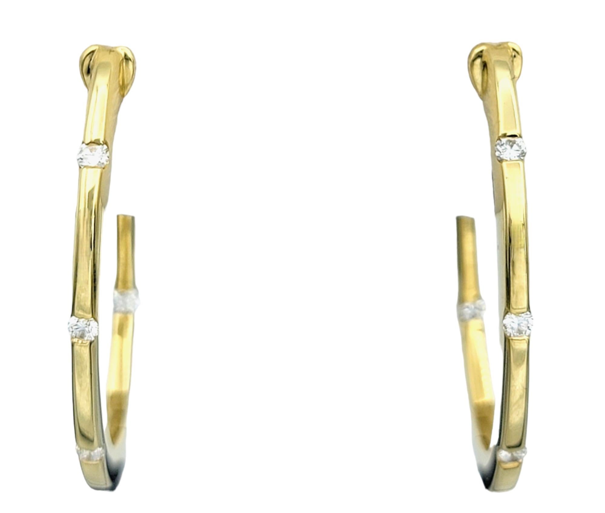 These stunning hoop earrings from Roberto Coin, crafted from luxurious 18 karat yellow gold, boast a timeless design adorned with dazzling diamonds, adding a touch of sophistication to any ensemble. The brilliance of the diamonds is perfectly
