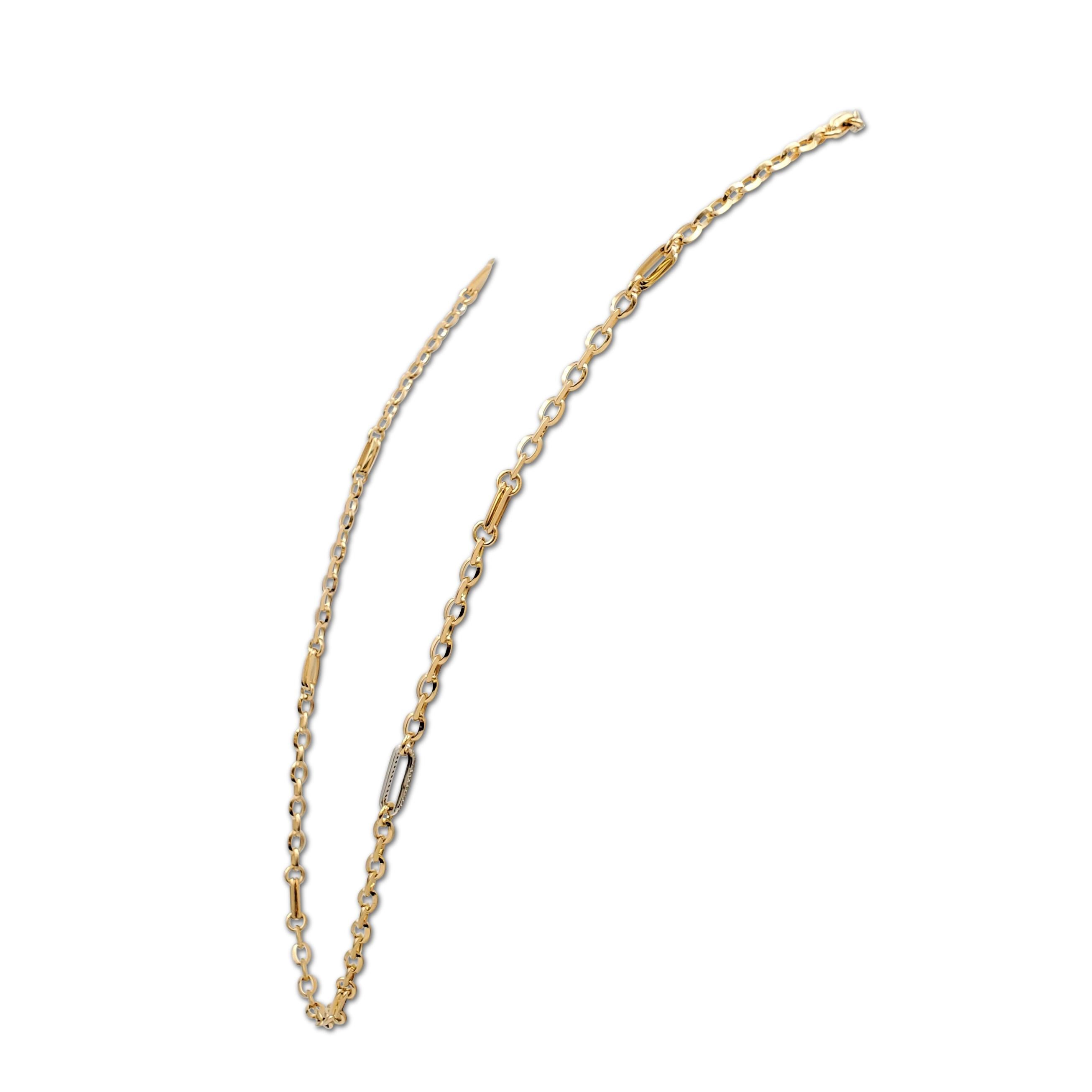Authentic Roberto Coin necklace crafted in 18 karat gold is comprised of oval-shaped yellow gold links with a white gold pave diamond set accent. Signed with signature Roberto Coin ruby stone at the clasp. The necklace is presented with the original