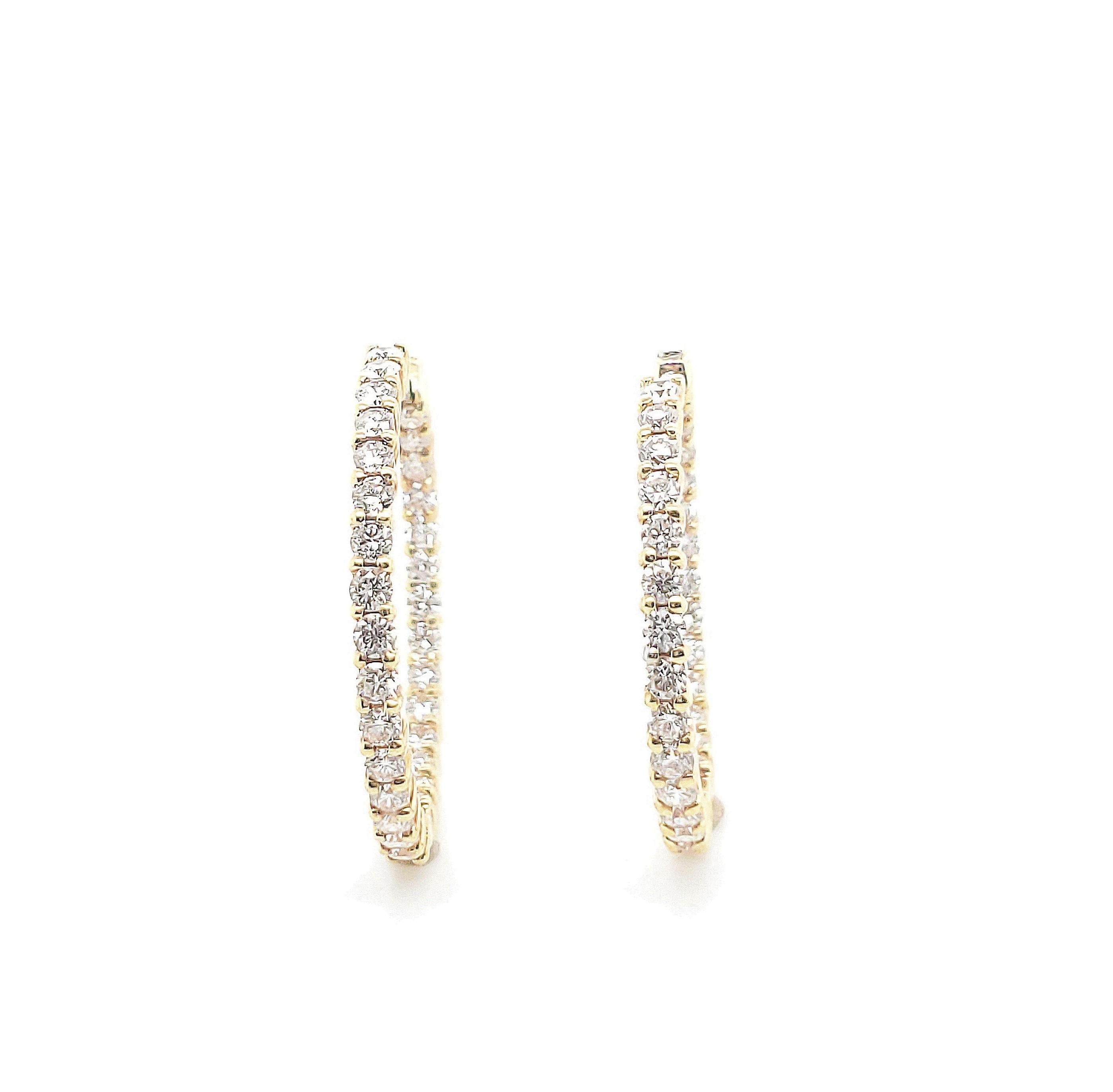 Authentic Roberto Coin 18 karat yellow gold hoop earrings set with approx. 2.5 carats of round brilliant cut diamonds (F color, VS clarity). Marked 1226VT 18K. Robert Coin signature ruby stone. Earrings measure 25mm x 32mm. Does not come with