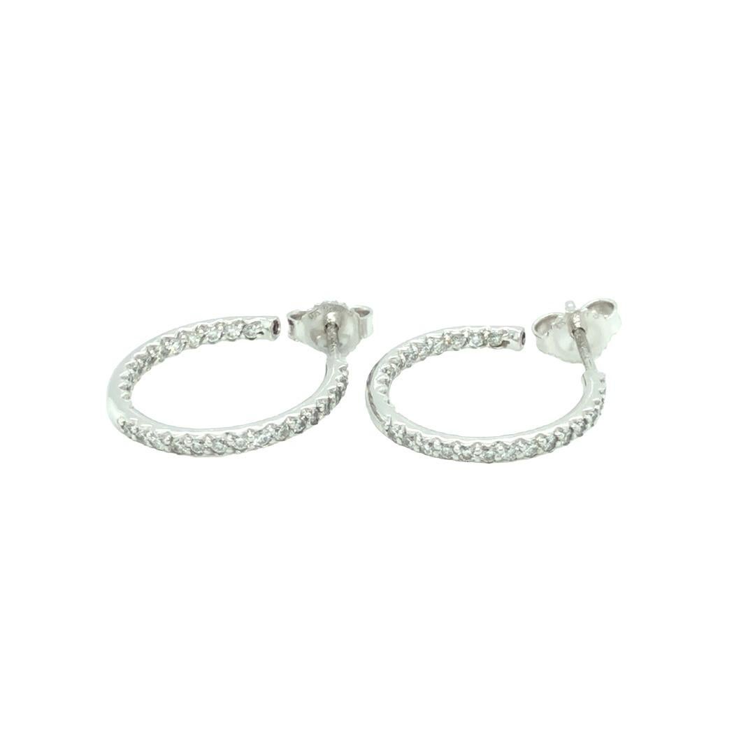 Classic Roberto Coin 18K white gold Inside Out Open Diamond Hoop Earrings in pristine condition. These modern classic earrings are perfect for your everyday wear. The earrings contain approximately 0.52 carat of round brilliant cut diamonds. Stamped