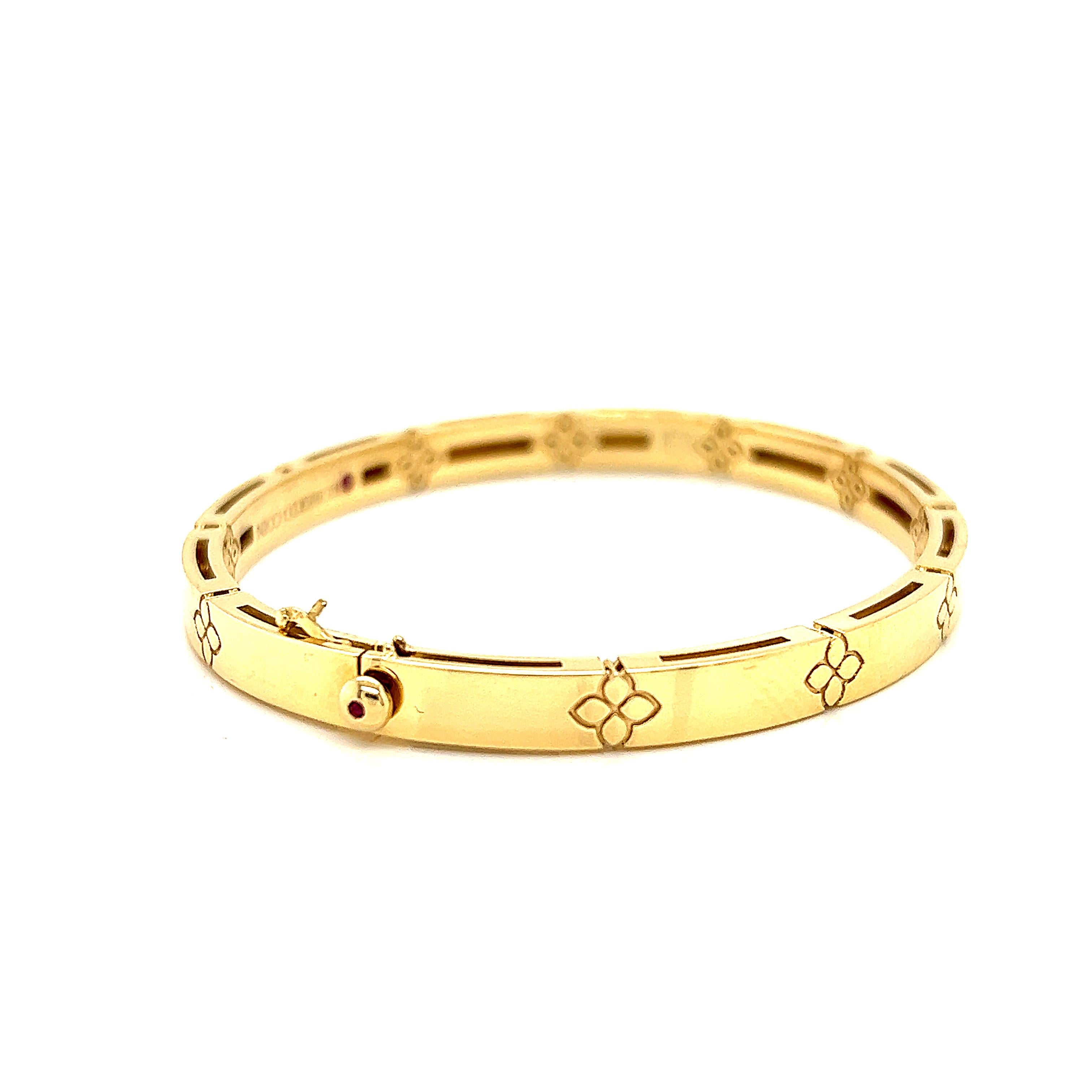 Crafted in 18K yellow gold with a classic high-polish finish, this elegant bangle from Roberto Coin's Love in Verona collection features a subtle debossed pattern of the designer's signature four petal flower. Measuring 6 mm wide this is the medium